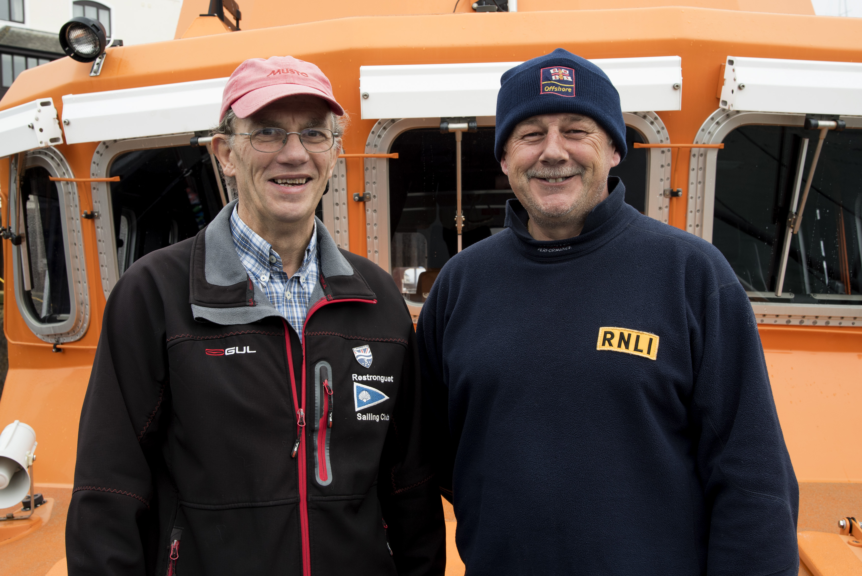 Henry Metcalfe, Restronguet Sailing Club Commodore with Falmouth RNLI Coxswain Jonathon Blakeston on board the station’s Severn class all-weather lifeboat Richard Cox Scott