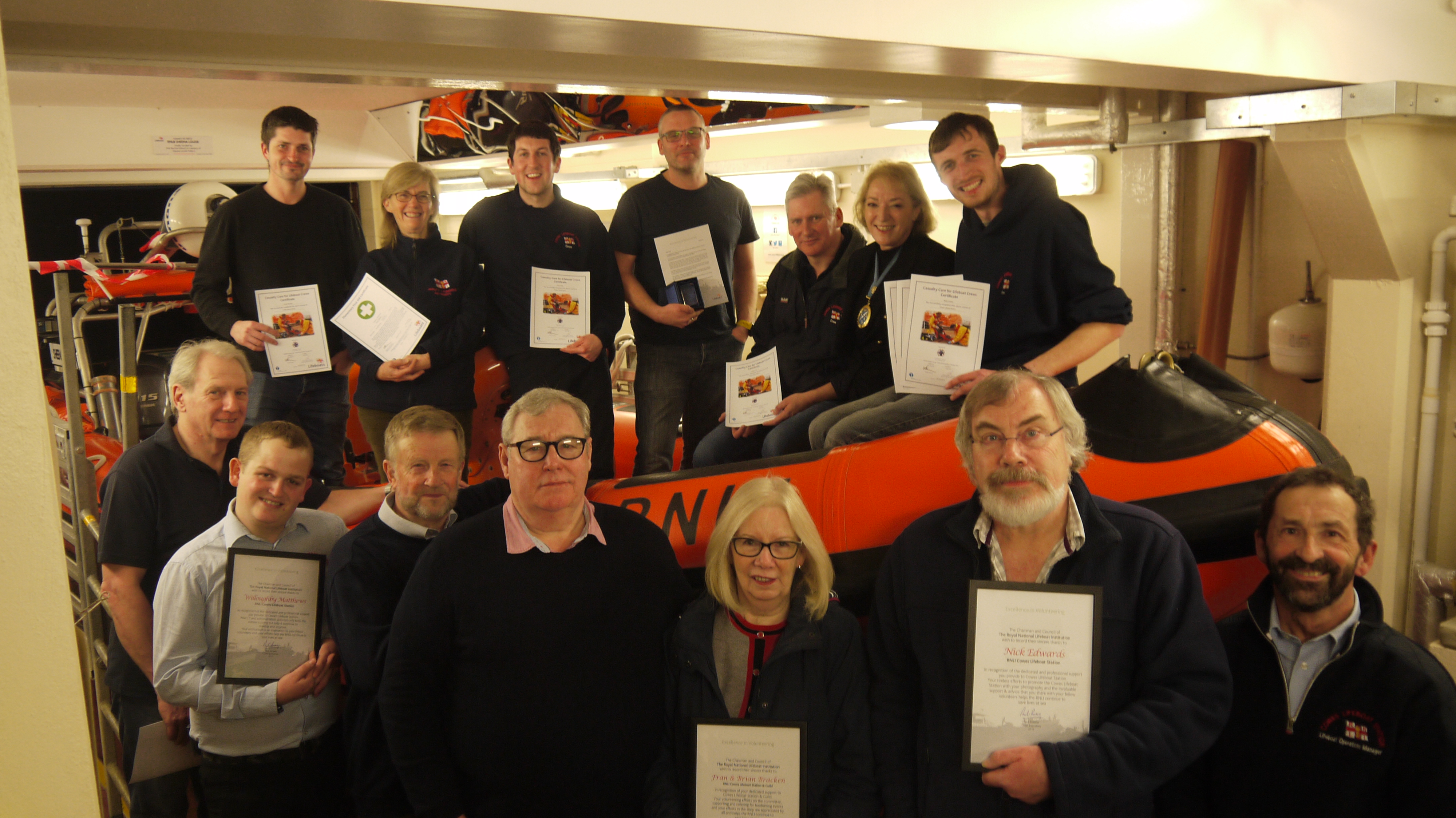 The High Sheriff, with lifeboat crew and shore crew members in the lifeboat station.