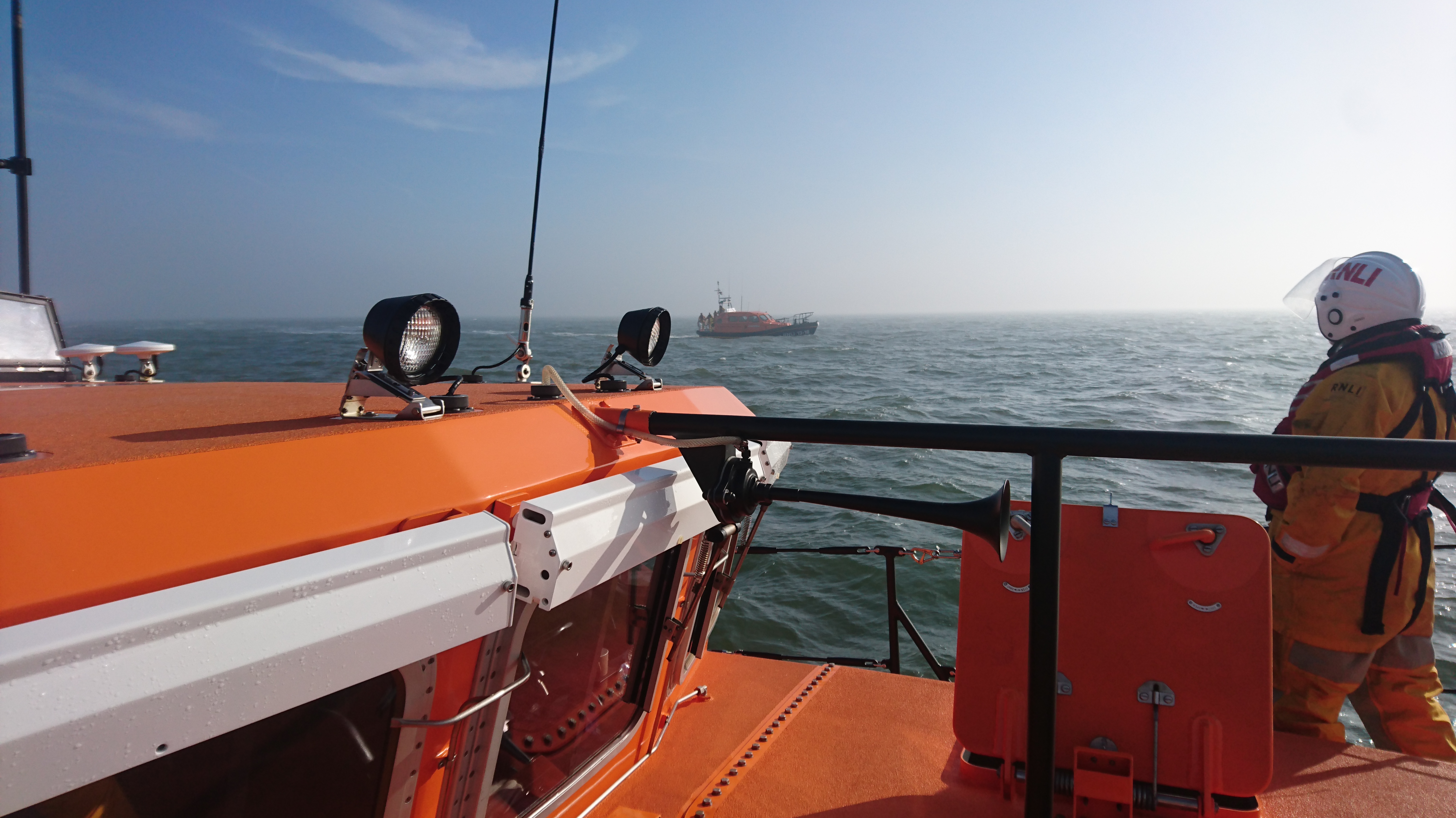 Llandudno lifeboat about to take oover tow of yacht from Rhyl lifeboat