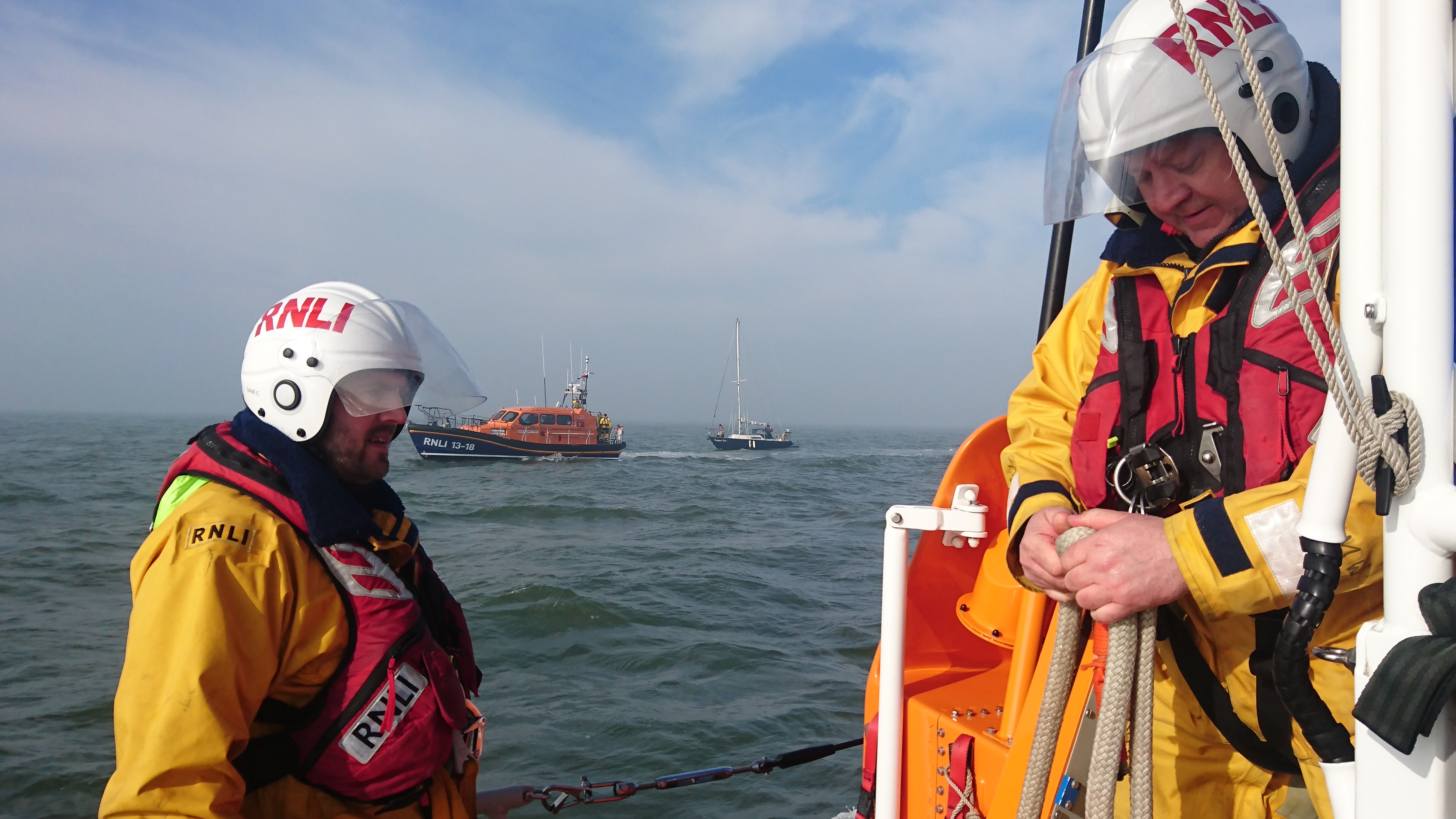 Llandudno lifeboat about to take over tow of yacht from Rhyl Lifeboat. David clark (L) and Mark Waterworth (R)