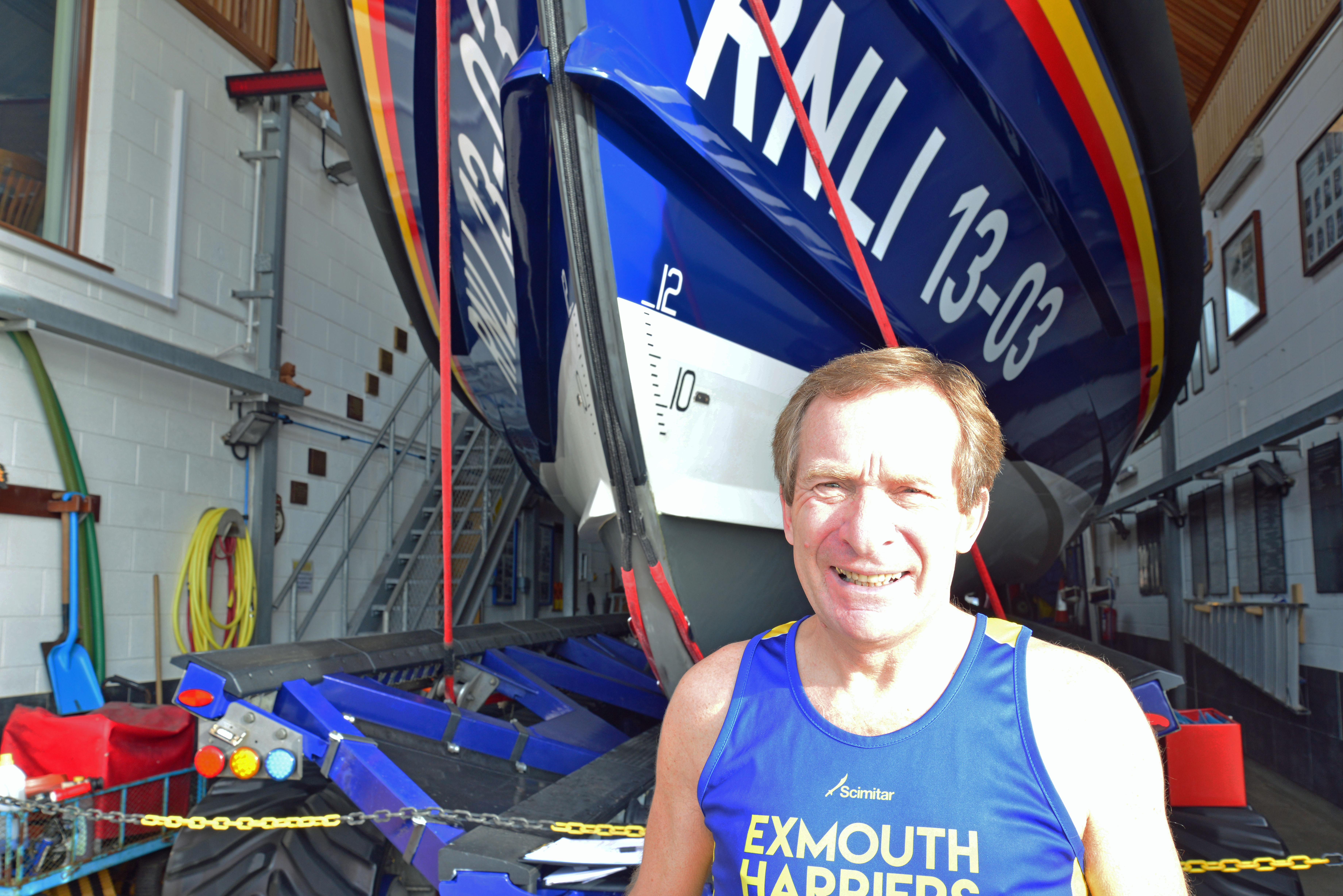 Volunteer Tour Guide, Des White in front of Exmouth's Shannon class lifeboat R and J Welburn