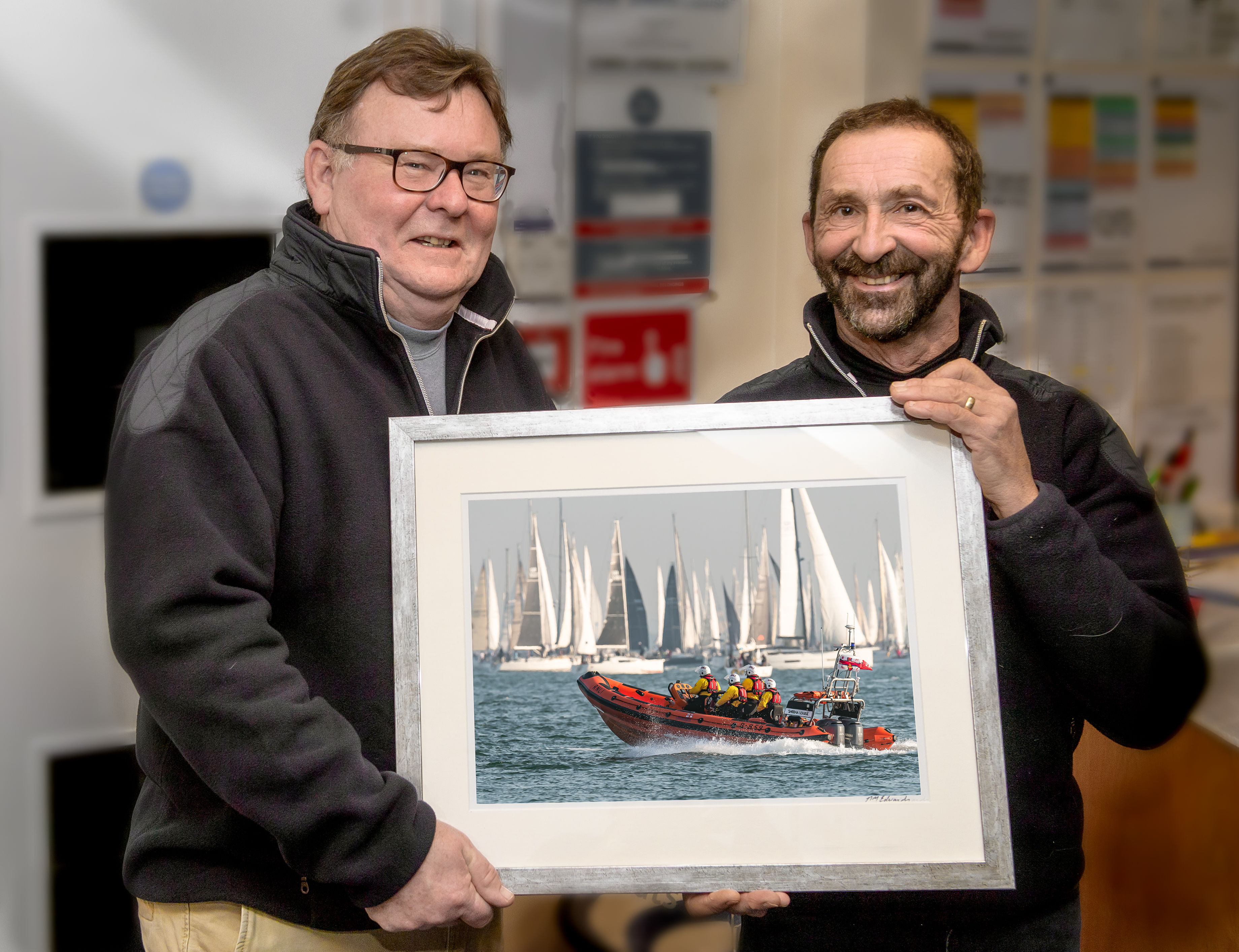 Presentation of the photo showing the lifeboat and Round the Island yacht race. Sandy (left) with Mark.