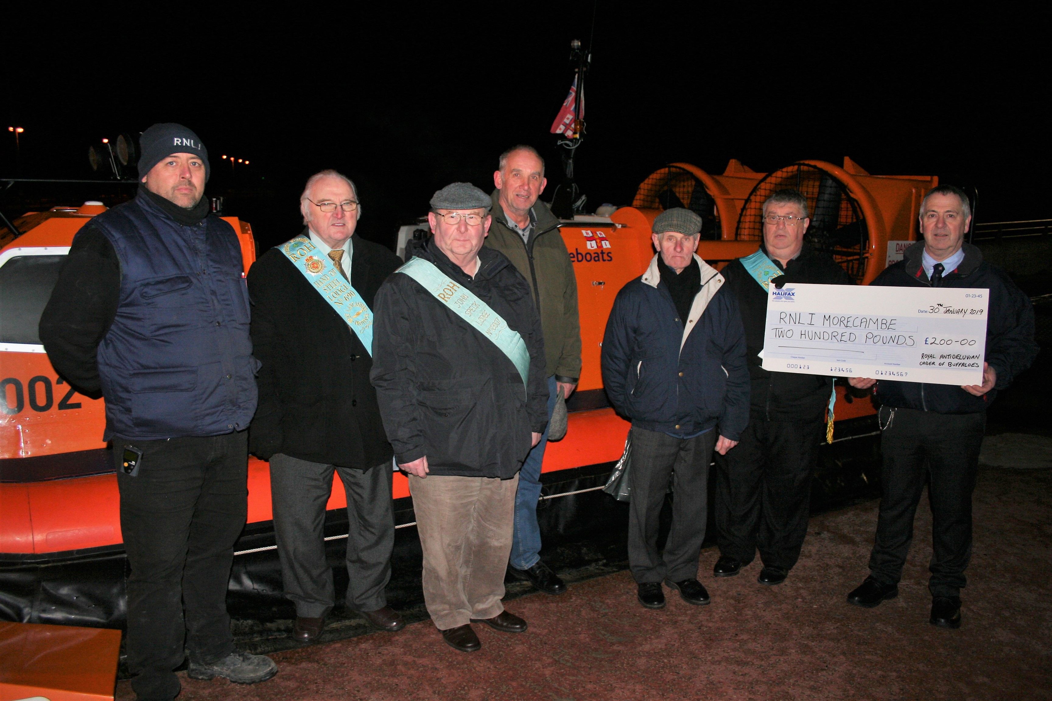 Volunteer RNLI Deputy Launching Authority, Mark Drew, receives the cheque.