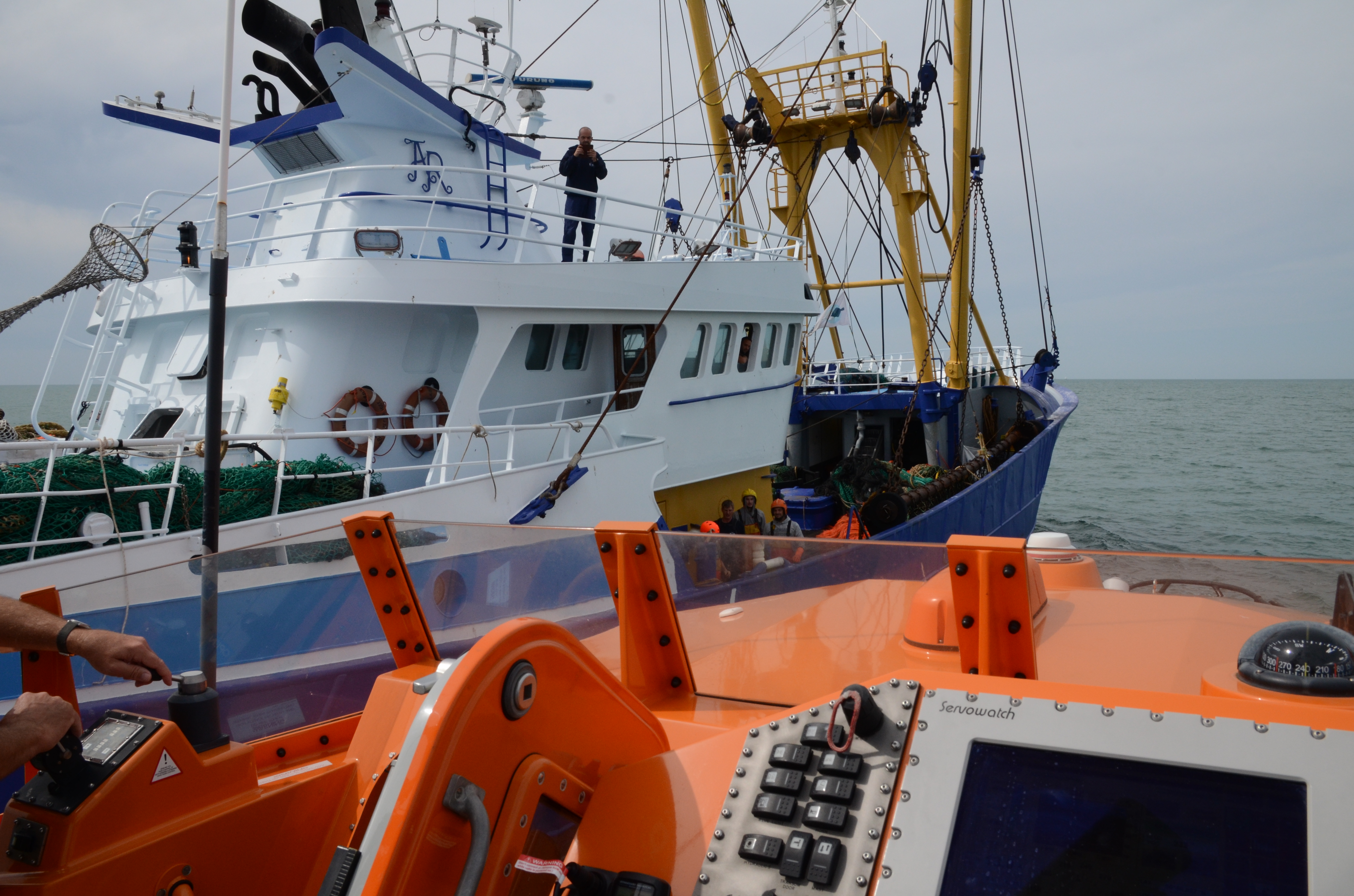 Lifeboat comes alongside trawler to collect crewman
