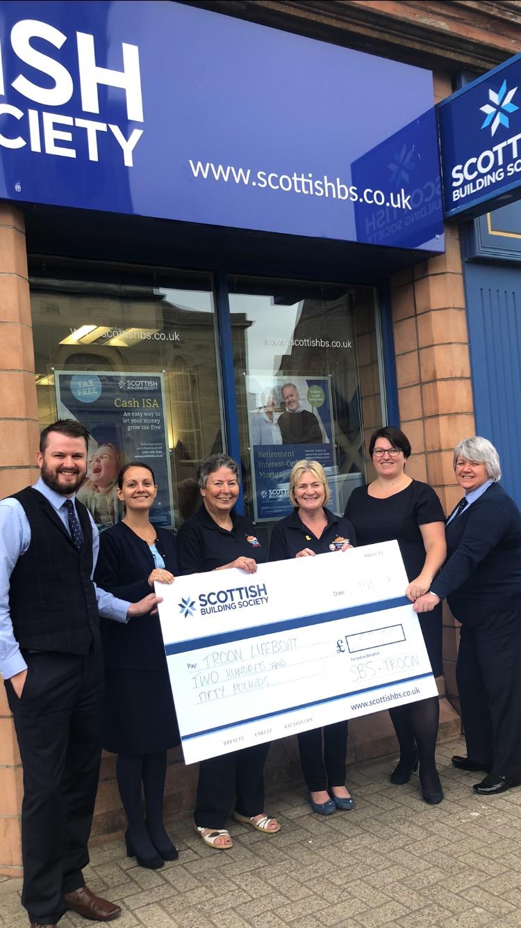 Pictured at the cheque handover are staff from the Scottish Building Society in Troon along with Urda Cotter and Margaret Ross of Troon RNLI Fundraising Branch.