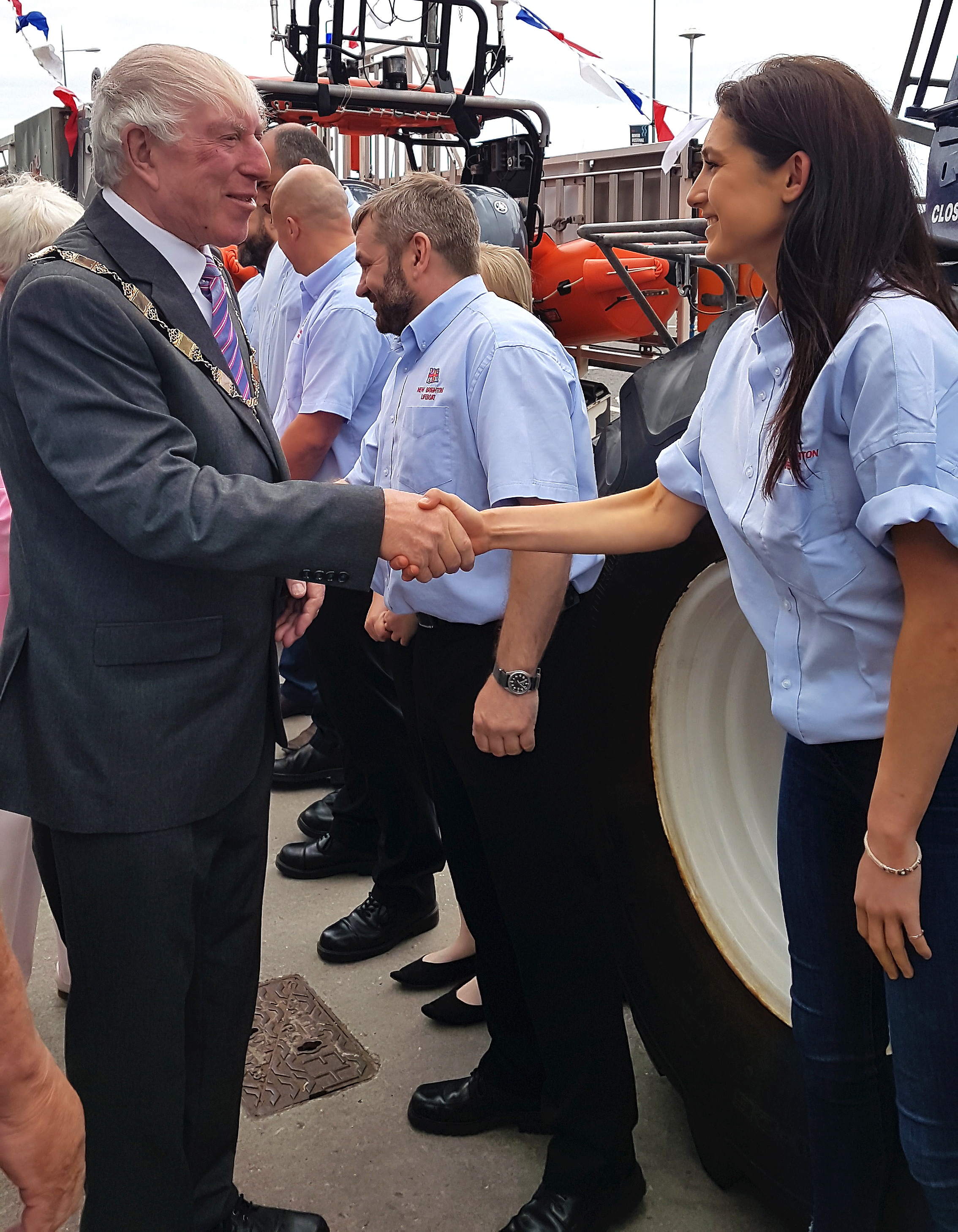 The deputy mayor shown shaking hands with Lucy as heads down the line of volunteer lifeboat crew