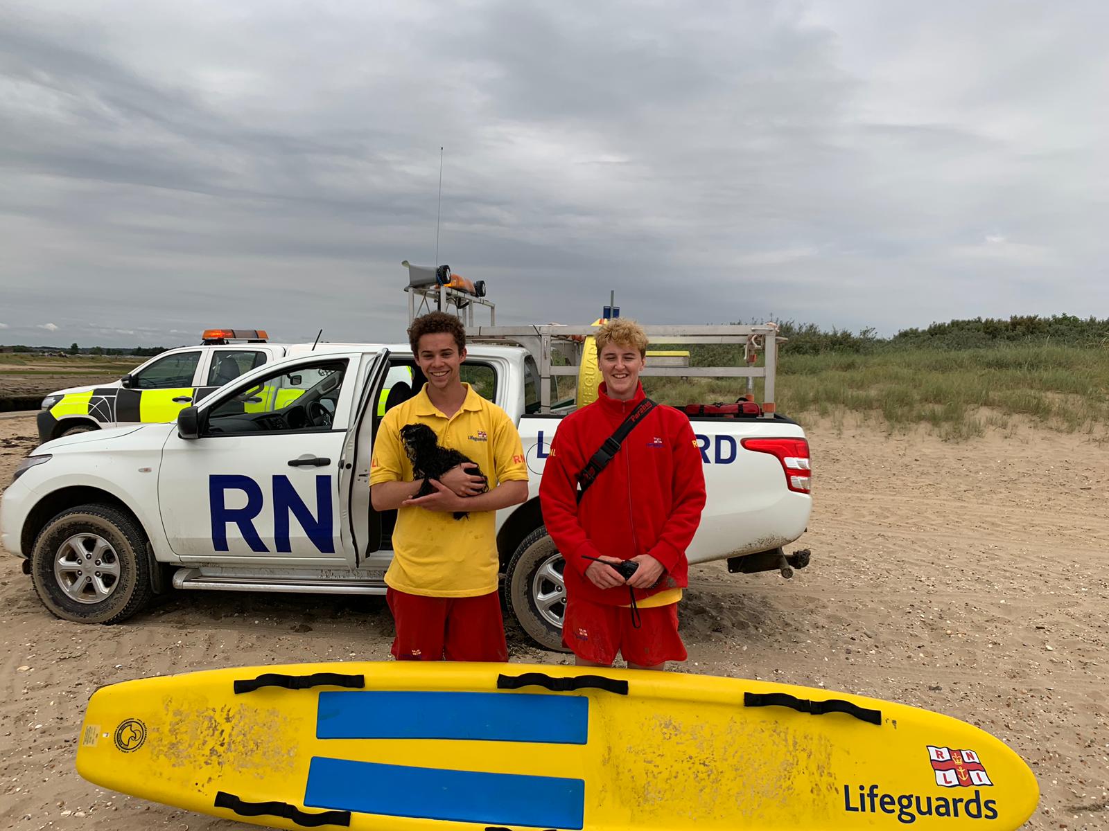 RNLI Lifeguards Georgia Landy and Laurence Petit with their tiny casualty