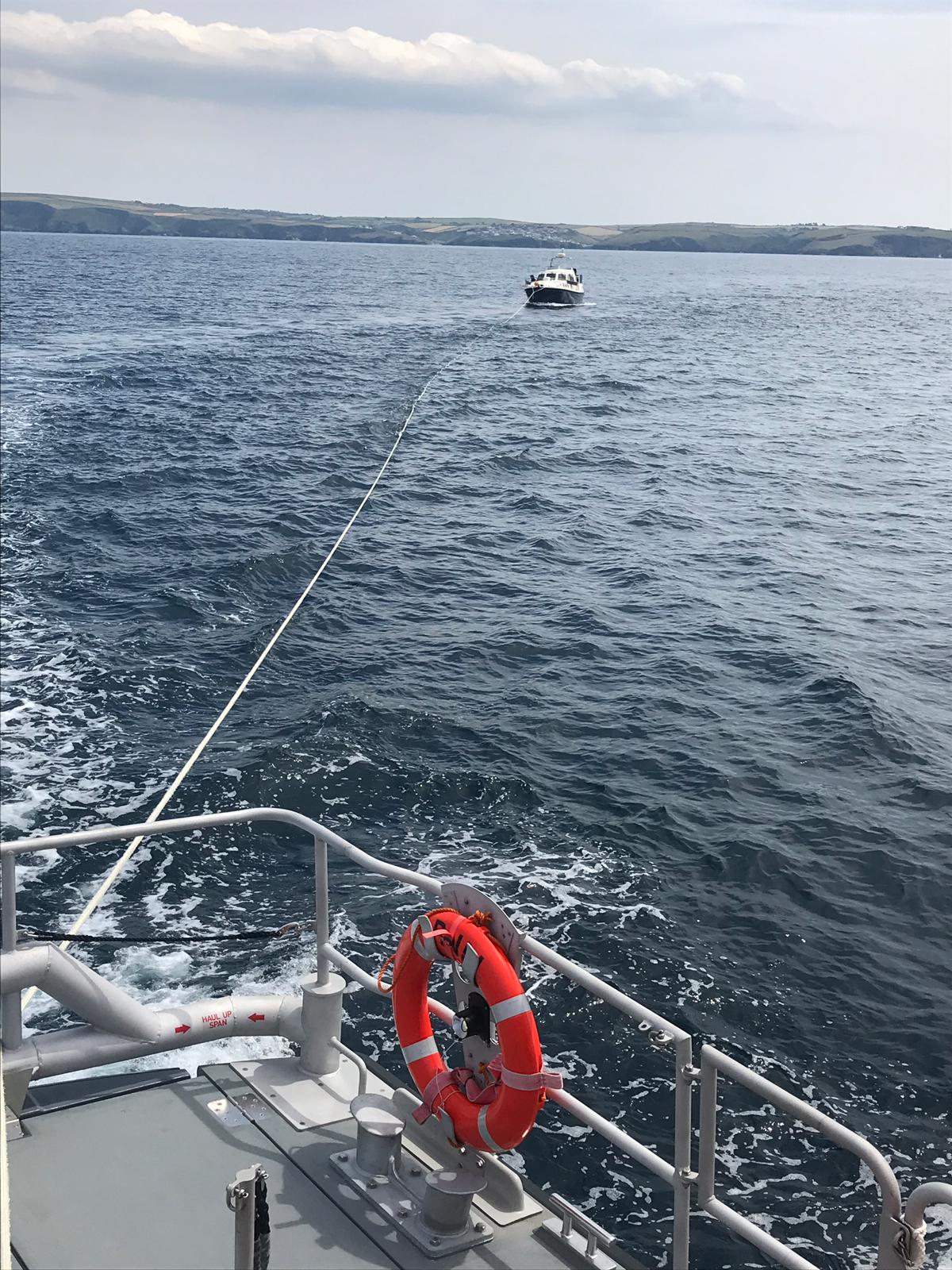 Motor cruiser under tow