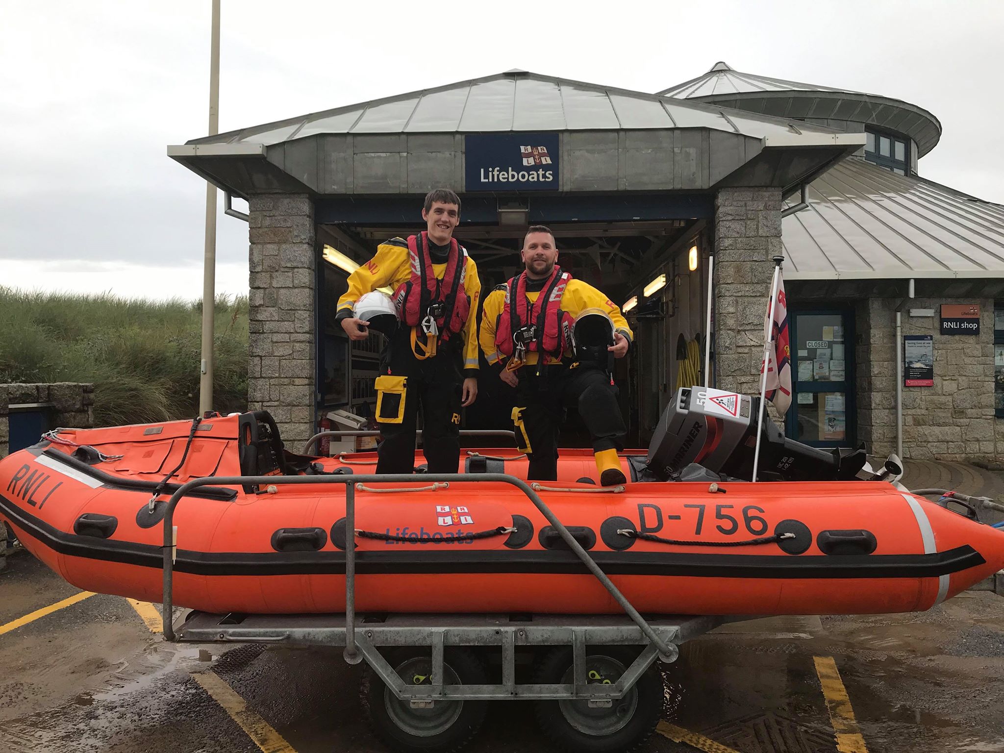 Volunteer lifeboat crew member James Lewis Bale and volunteer helm Dean Thompson in Bude's D class charity lifeboat outside Bude boathouse at Summerleaze beach