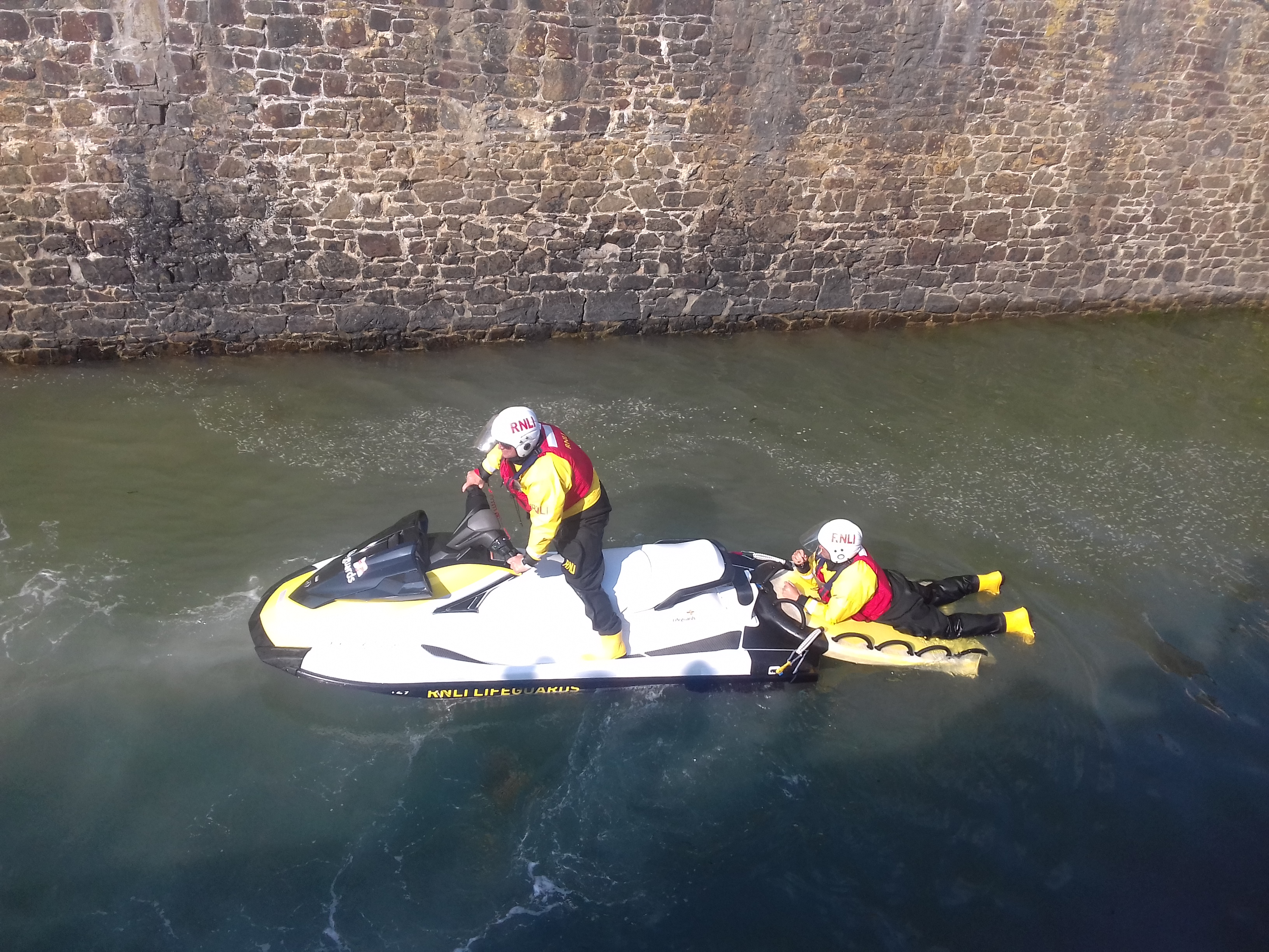 Bude volunteer lifeboat crew arriving at the lock gates on board the Rescue Water Craft (RWC) for the Blessing of the Sea service.