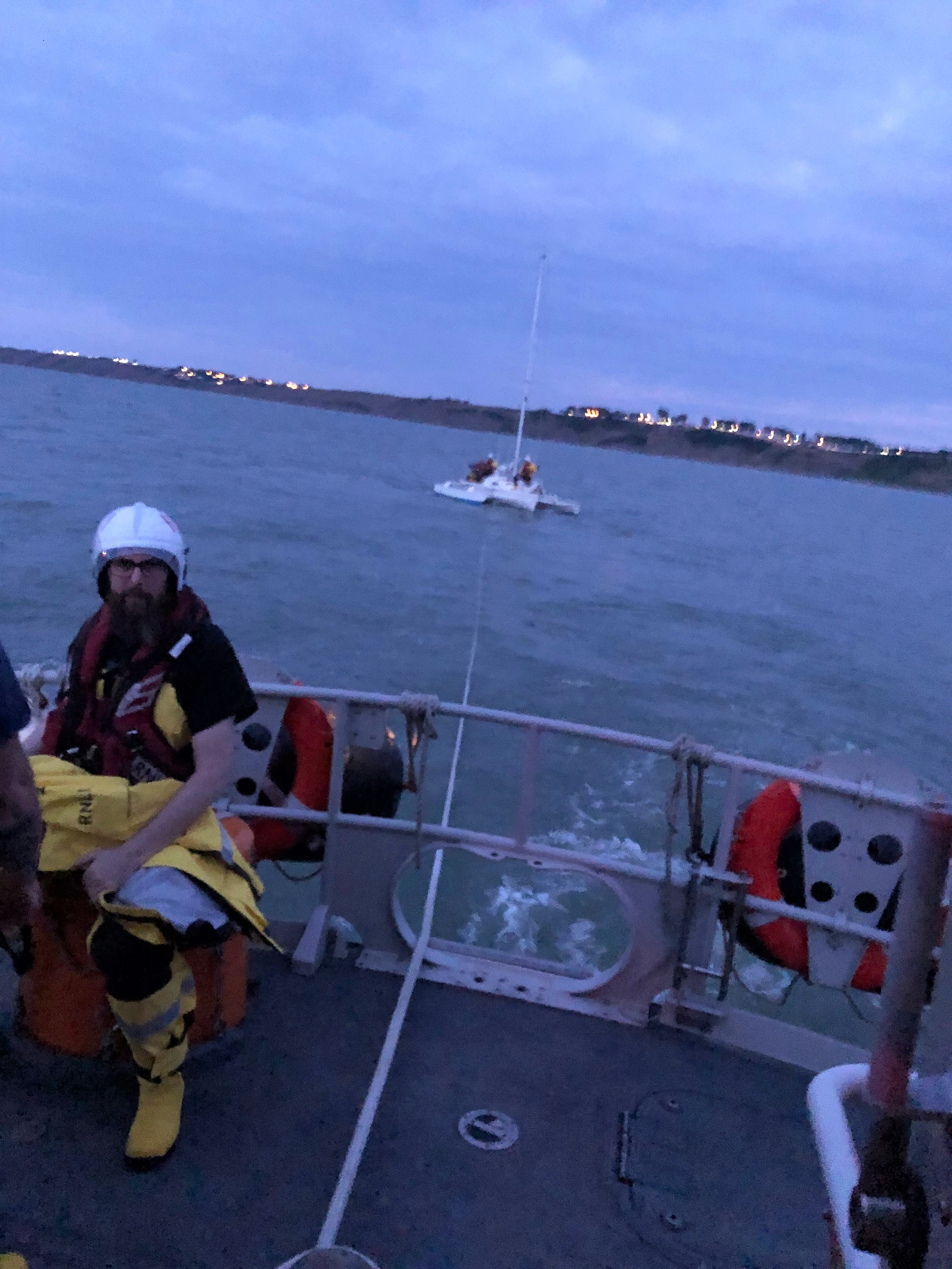 The trimaran safely under tow.