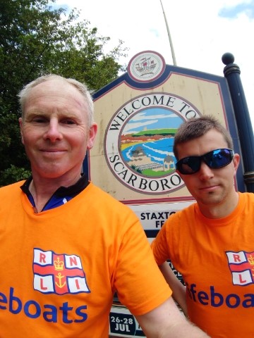 Blackpool RNLI Volunteer Nick (L) &amp; friend Chris in front of welcome to Scarborough sign