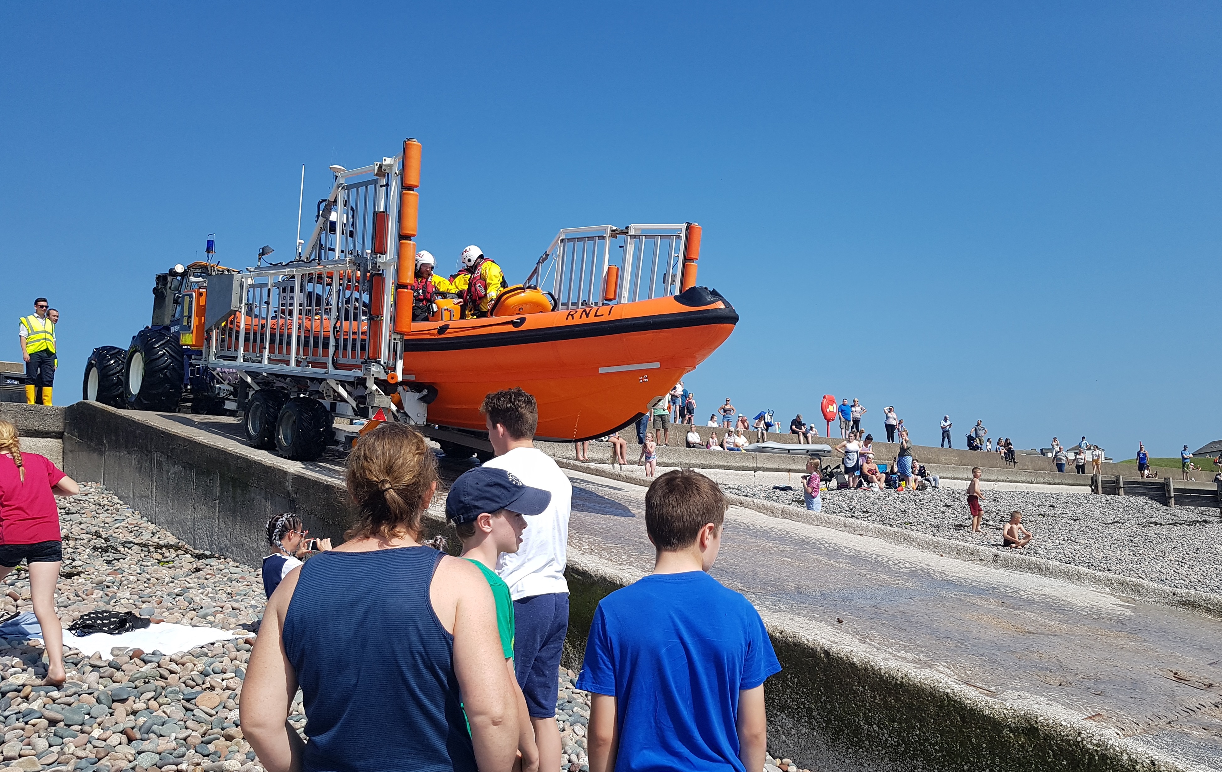 Returning back to the lifeboat station watched by holiday makers and locals enjoyng the sun.