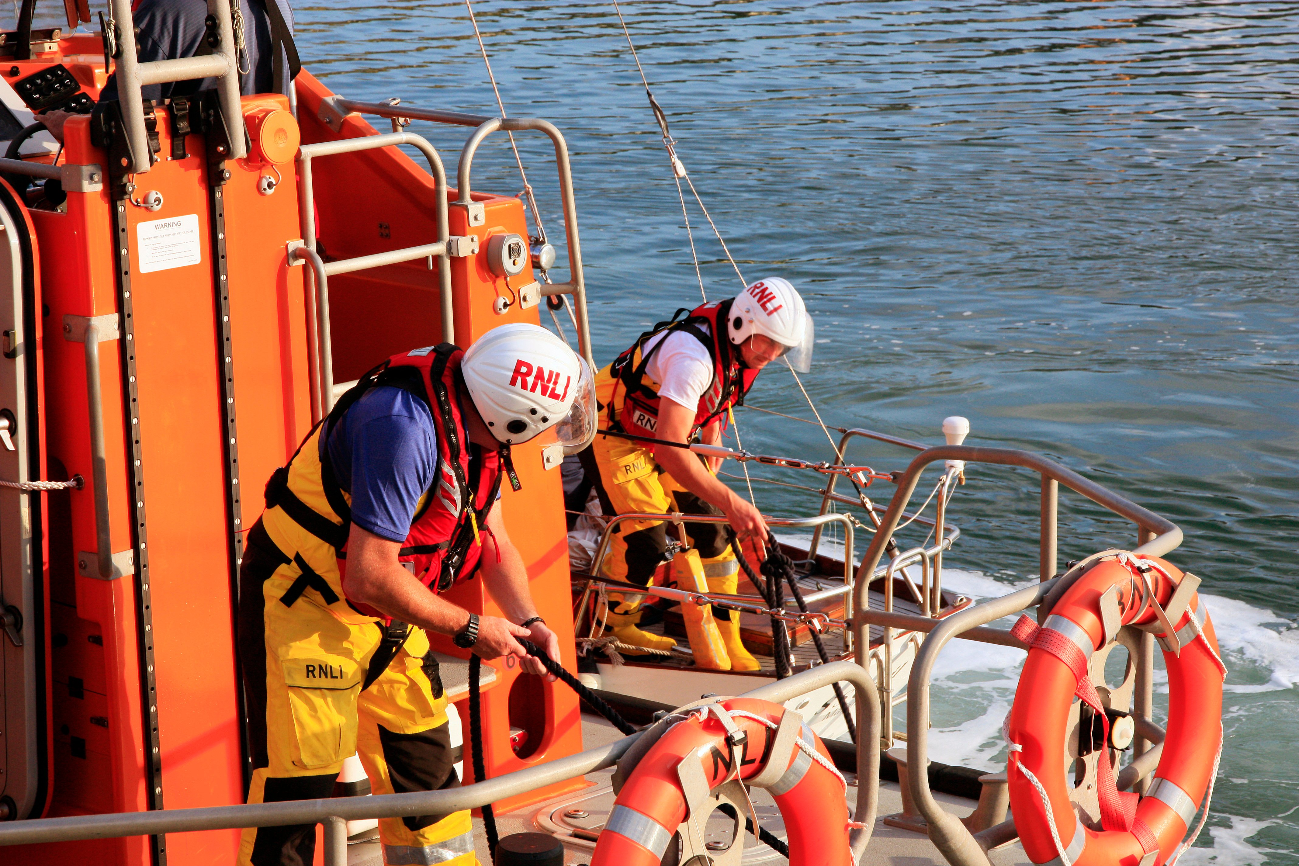 Wicklow RNLI volunteers bring the yacht alongside the East pier at Wicklow harbour