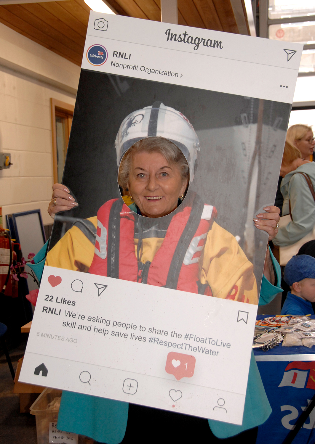The borough mayor, Cllr Hazel Lynskey, holding an RNLI Instagram poster