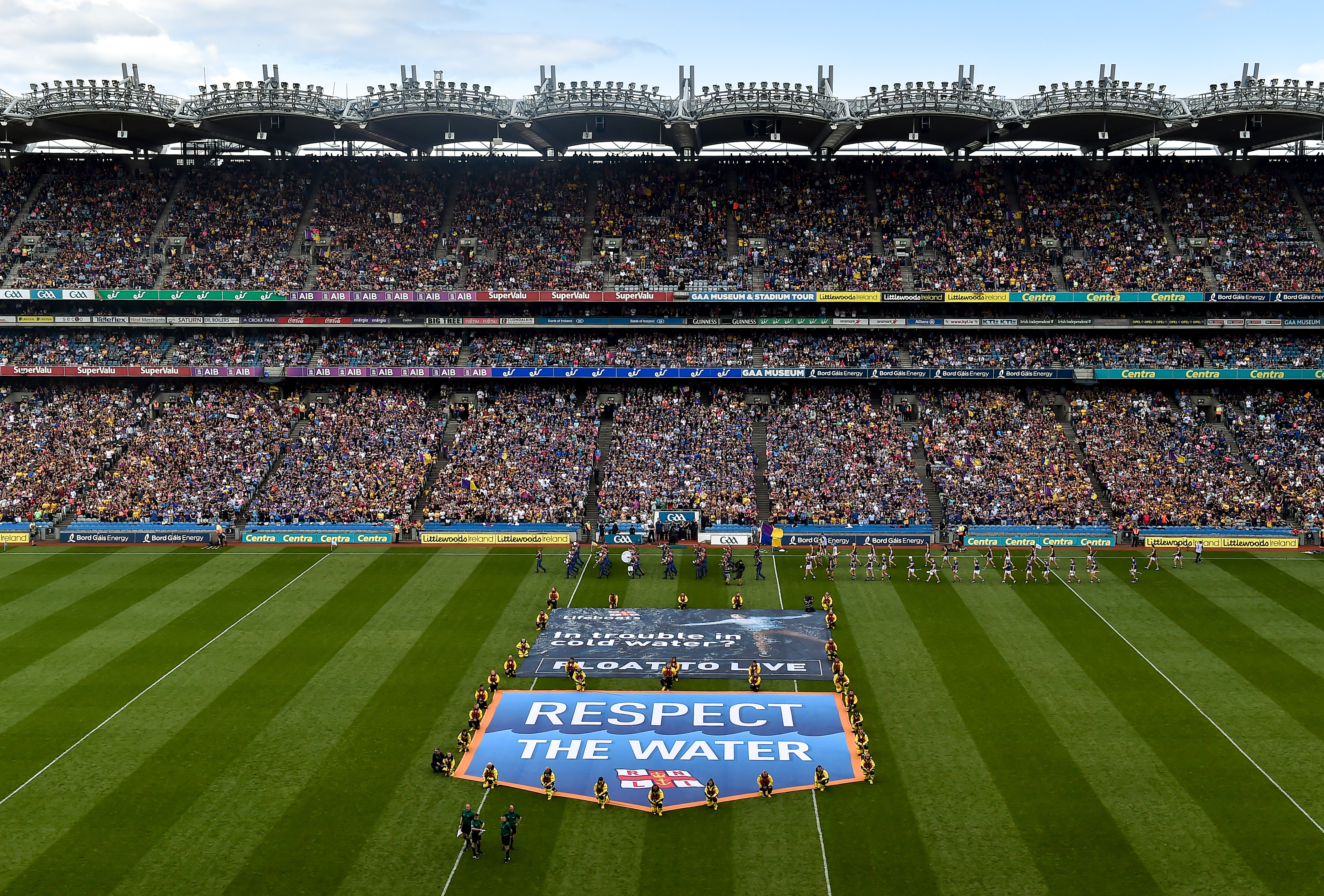RNLI lifeboat crew unfurl Respect the Water banners on the pitch at Croke Park
