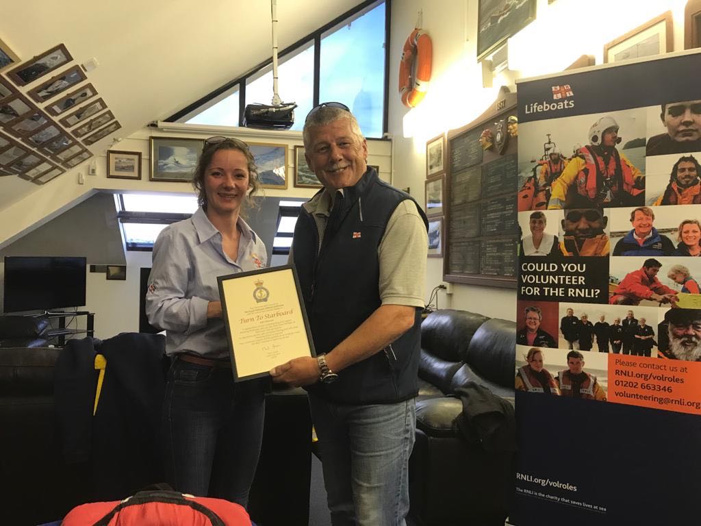 Coxswain Jon Blakeston presenting Tamsin Mulcahy of Turn to Starboard with a certificate of thanks
