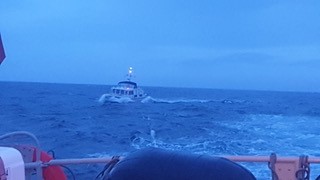 Islay RNLI with French motor cruiser under tow