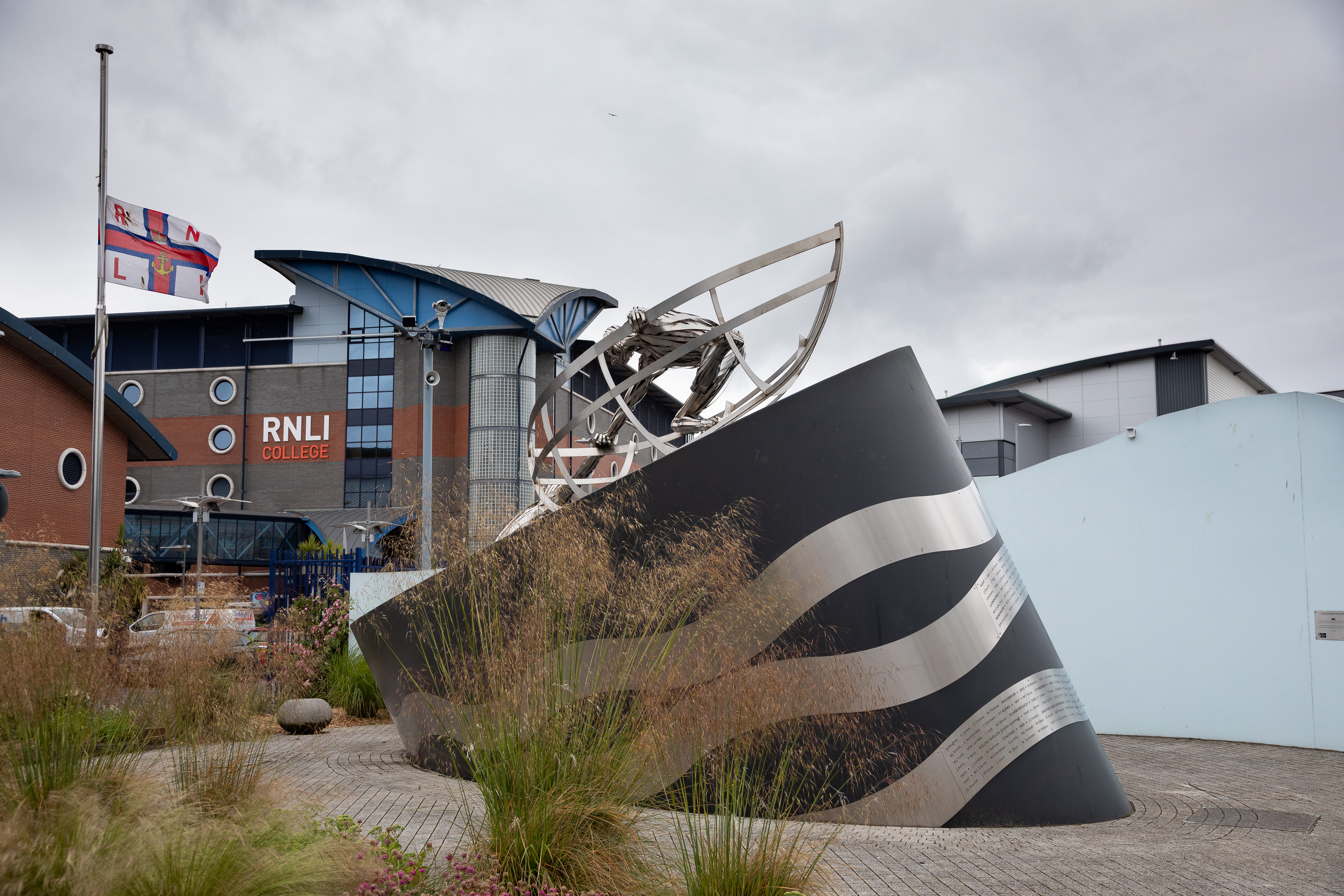 RNLI Flag at Half-Mast with Memorial Scultpure
