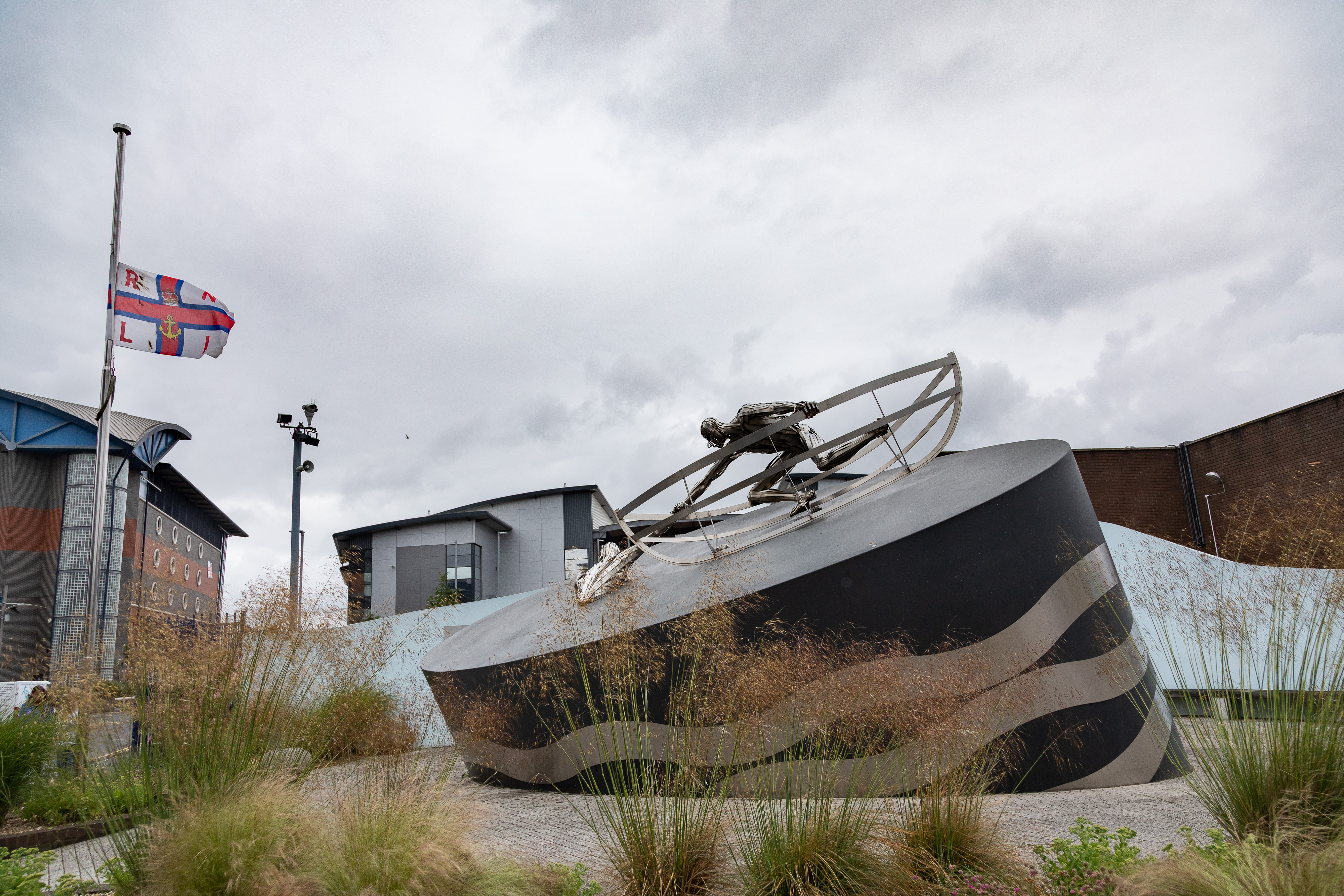 Half-mast flag with memorial sculpture 