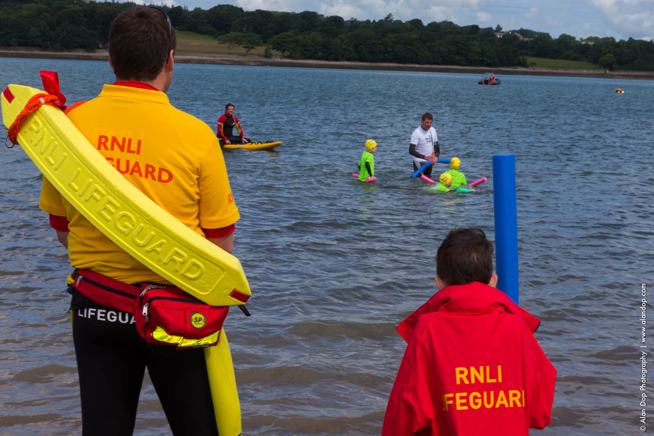 Young boy and lifeguard keeping an eye on the Swim Safe session at Plas Menai