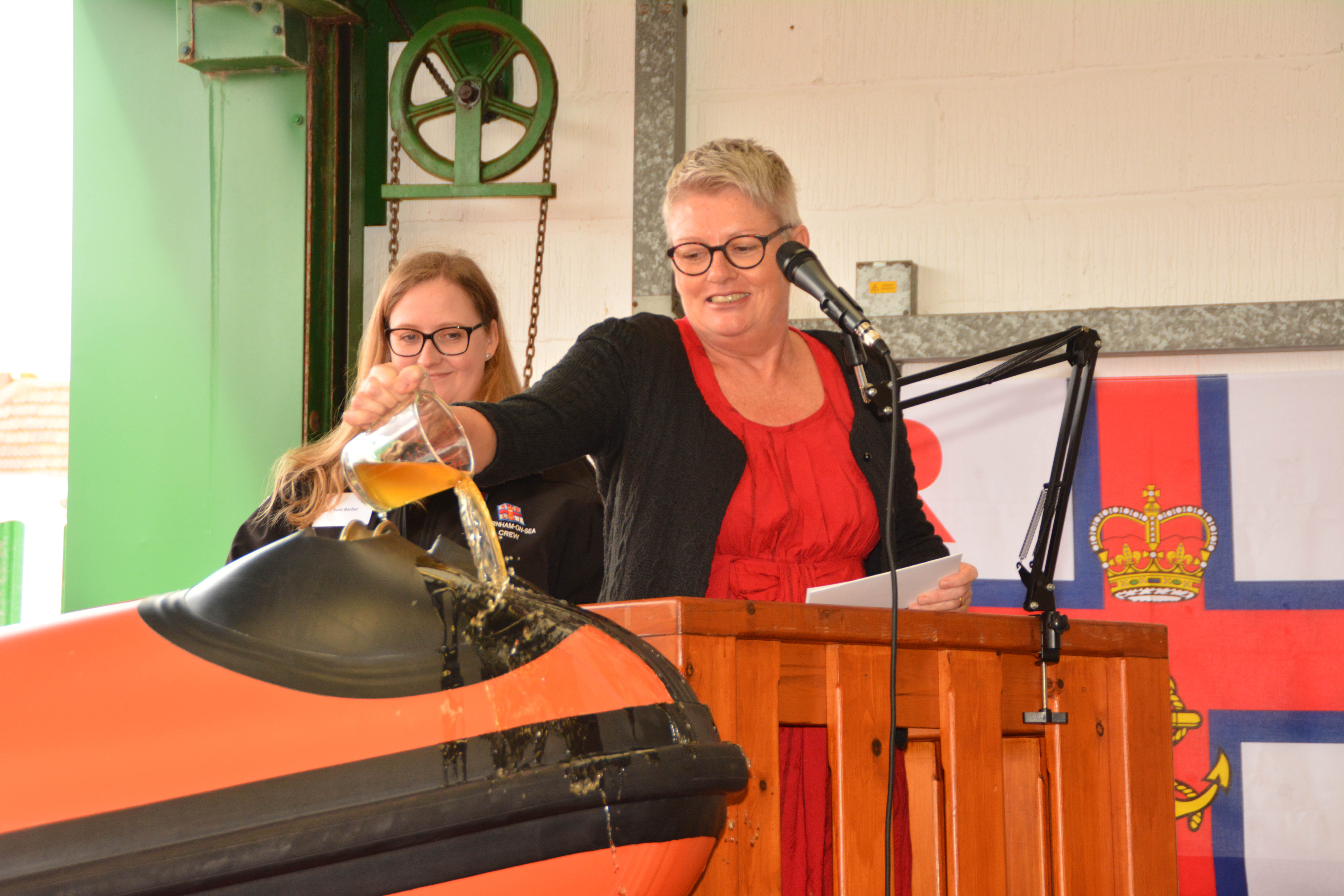 Allison Reshad names the lifeboat by pouring local cider over the bow