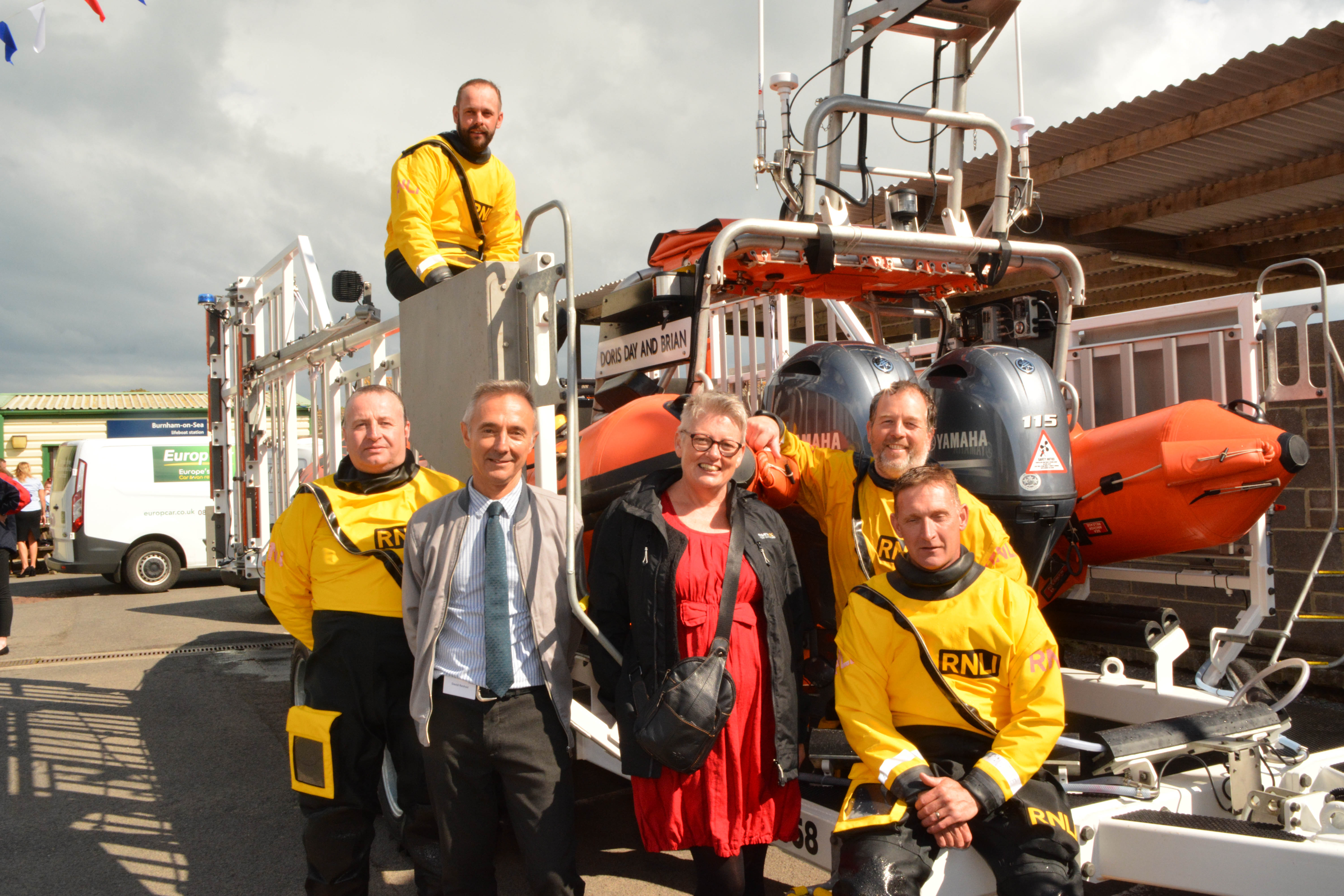 Allison and her husband with the crew of Doris Day and Brian at the stern of the lifeboat