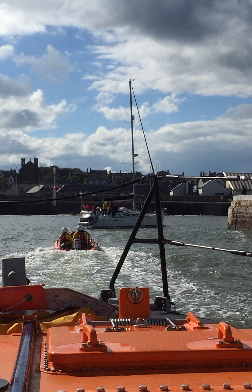 Yacht being escorted into harbour by Arbroath lifeboats