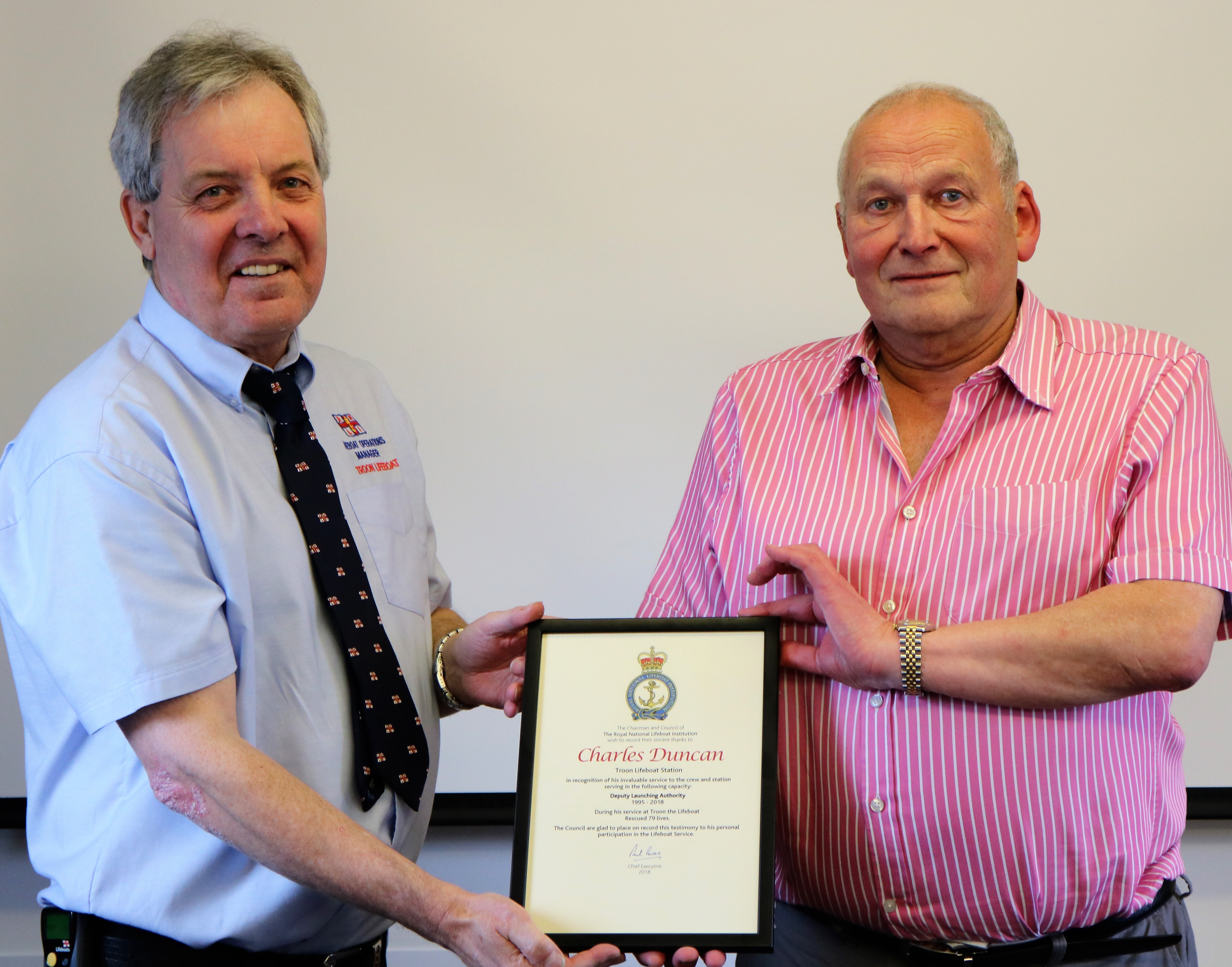 Pictured is Troon Lifeboat Operations Manager Jim Redmond (left) presenting the leaving certificate to Charlie Duncan