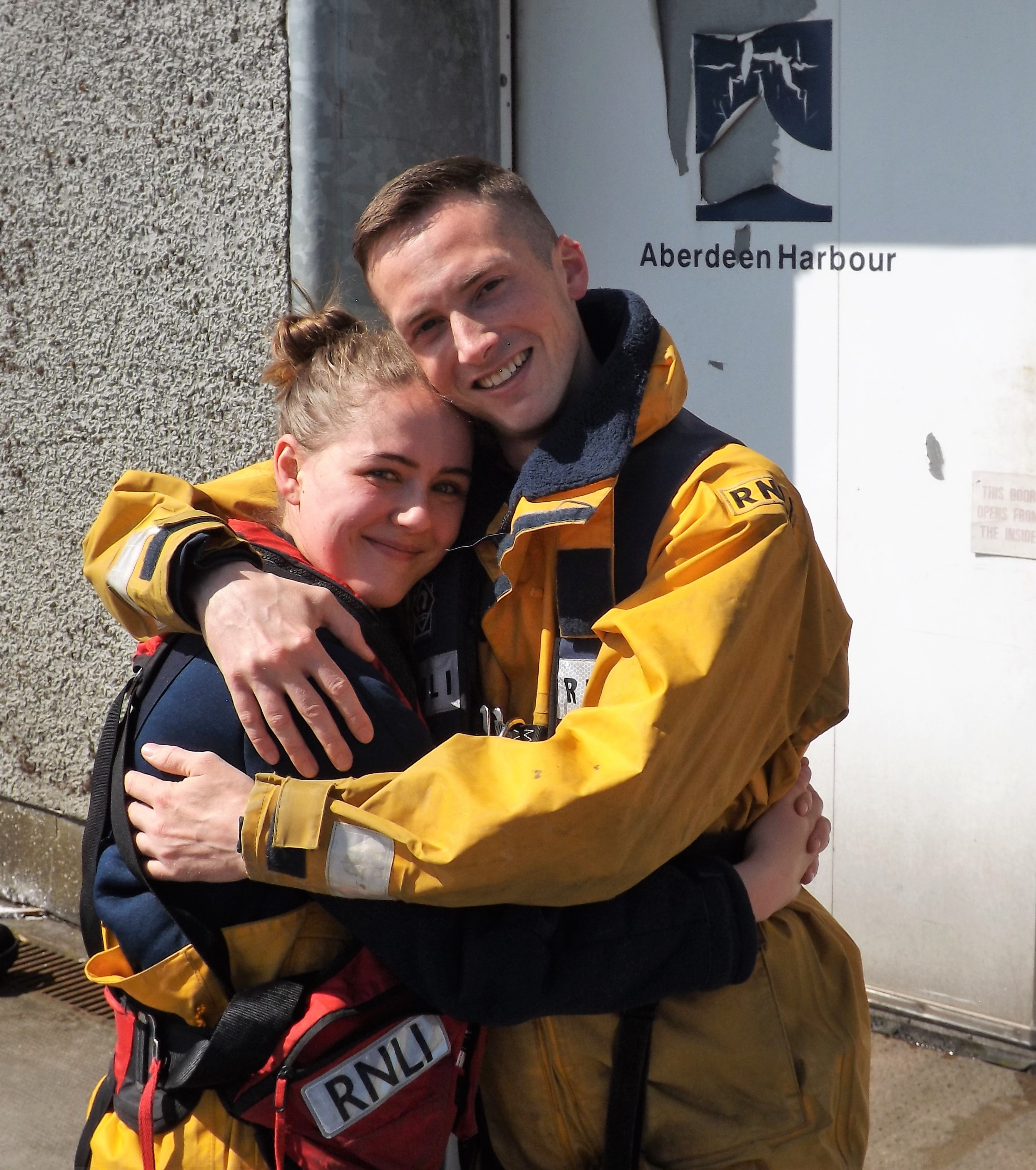 Newly engaged Sam and Kirsty join crewmates onboard the RNLI lifeboat 'Bon Accord' for a photo