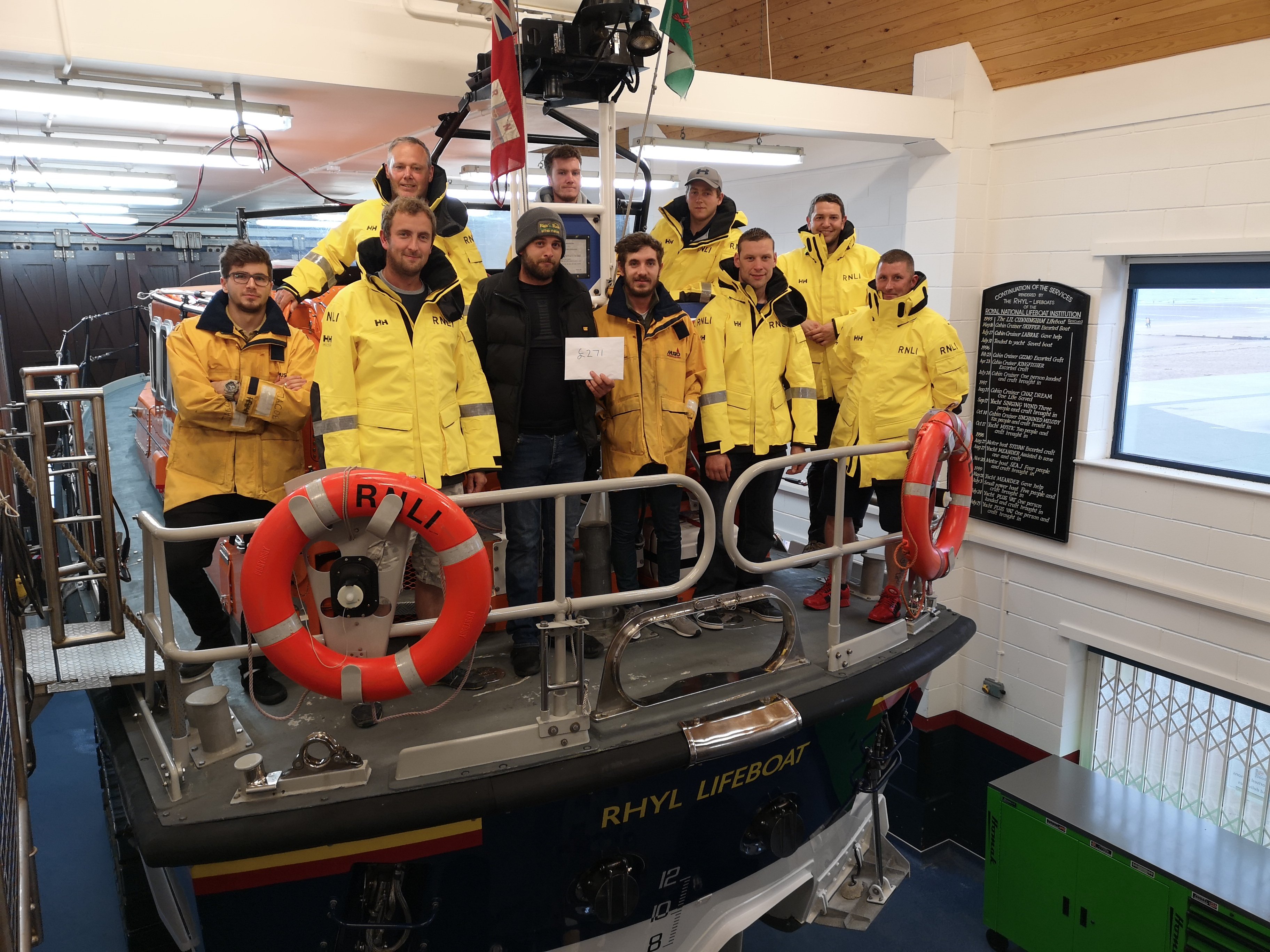 Duty Coxswain Andrew Wilde to left of Luw with other crew members