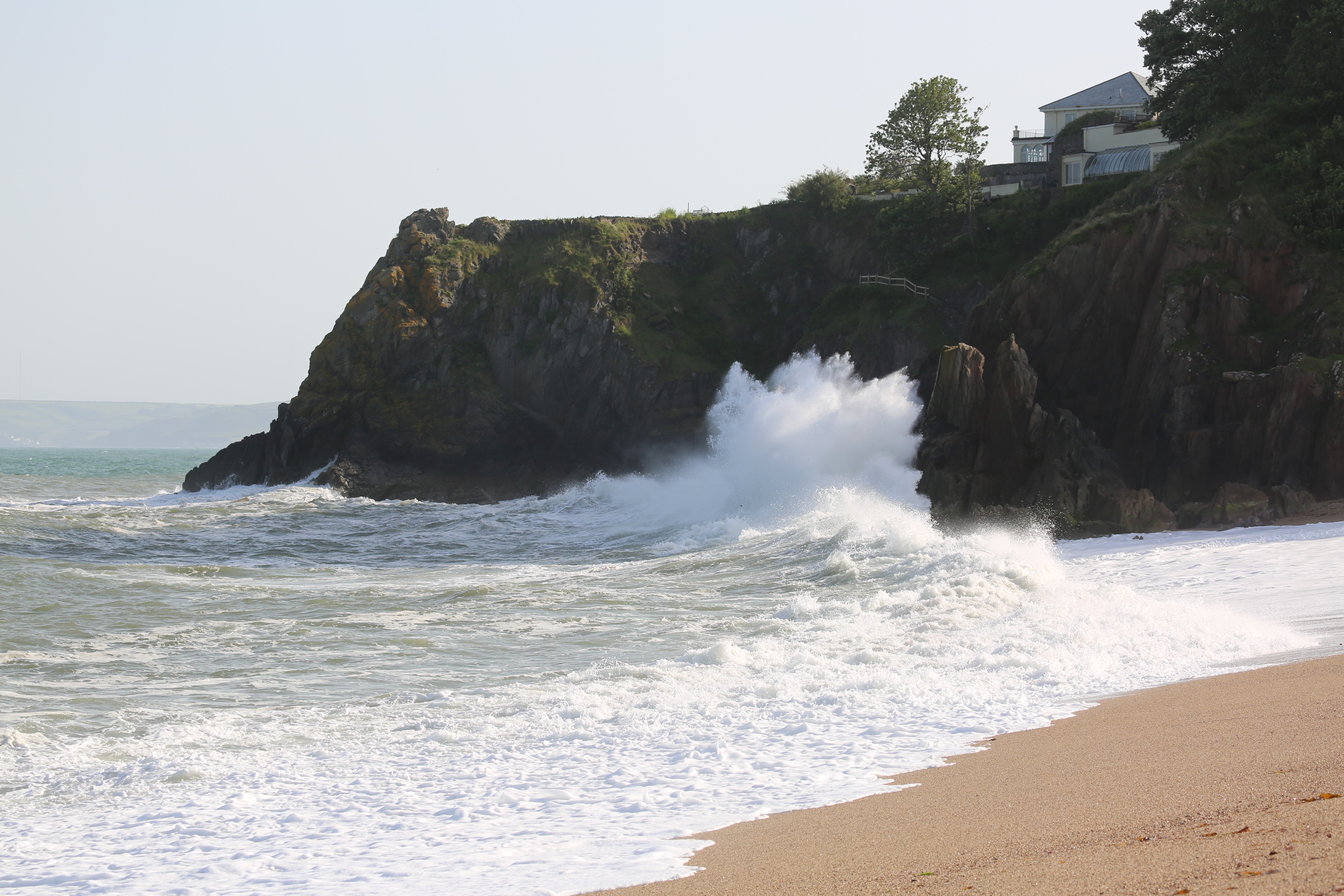 Waves were breaking half way up the cliff where the kayakers swam ashore.