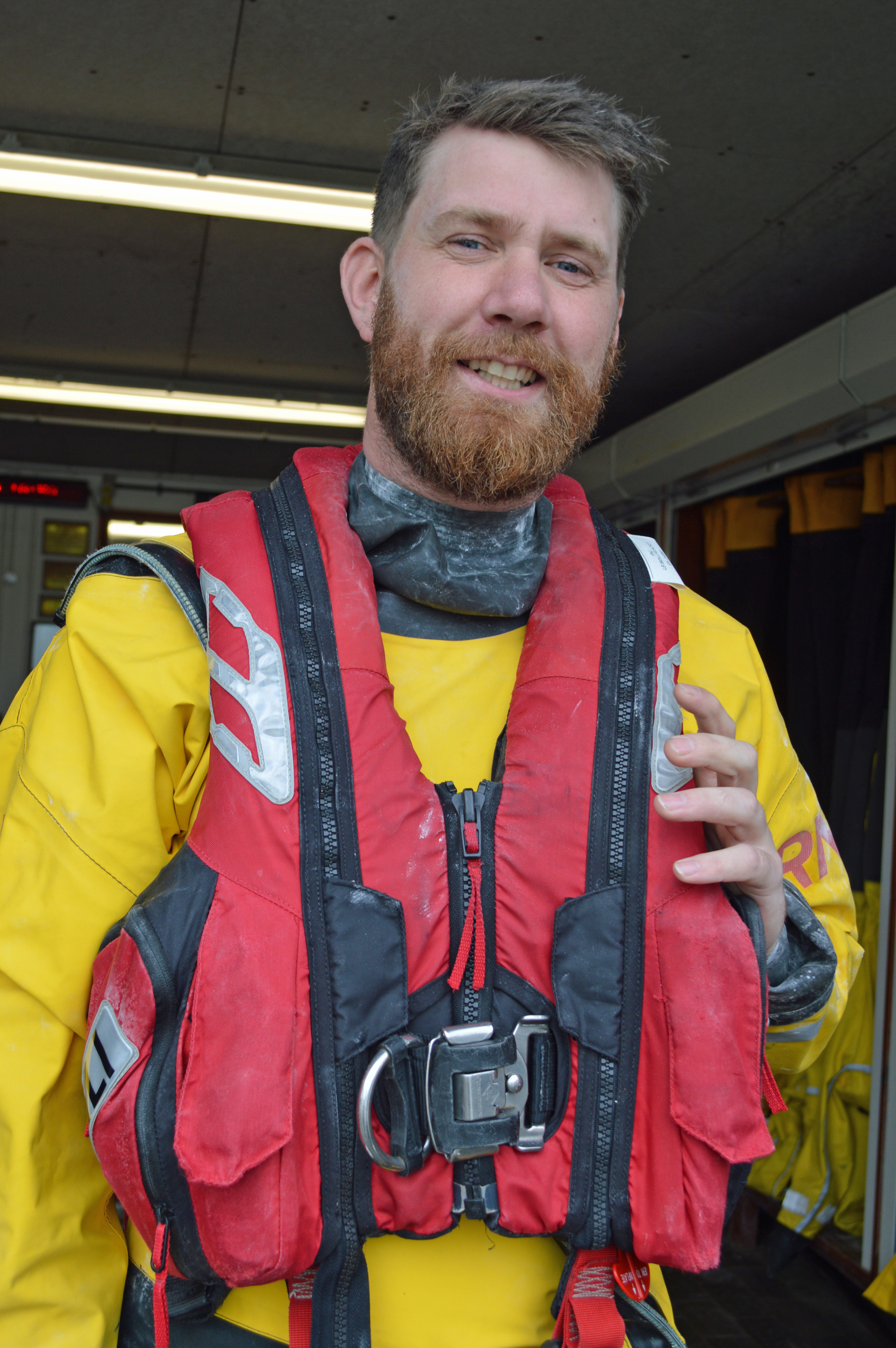 Tom in his crew kit smiling at the camera at the station