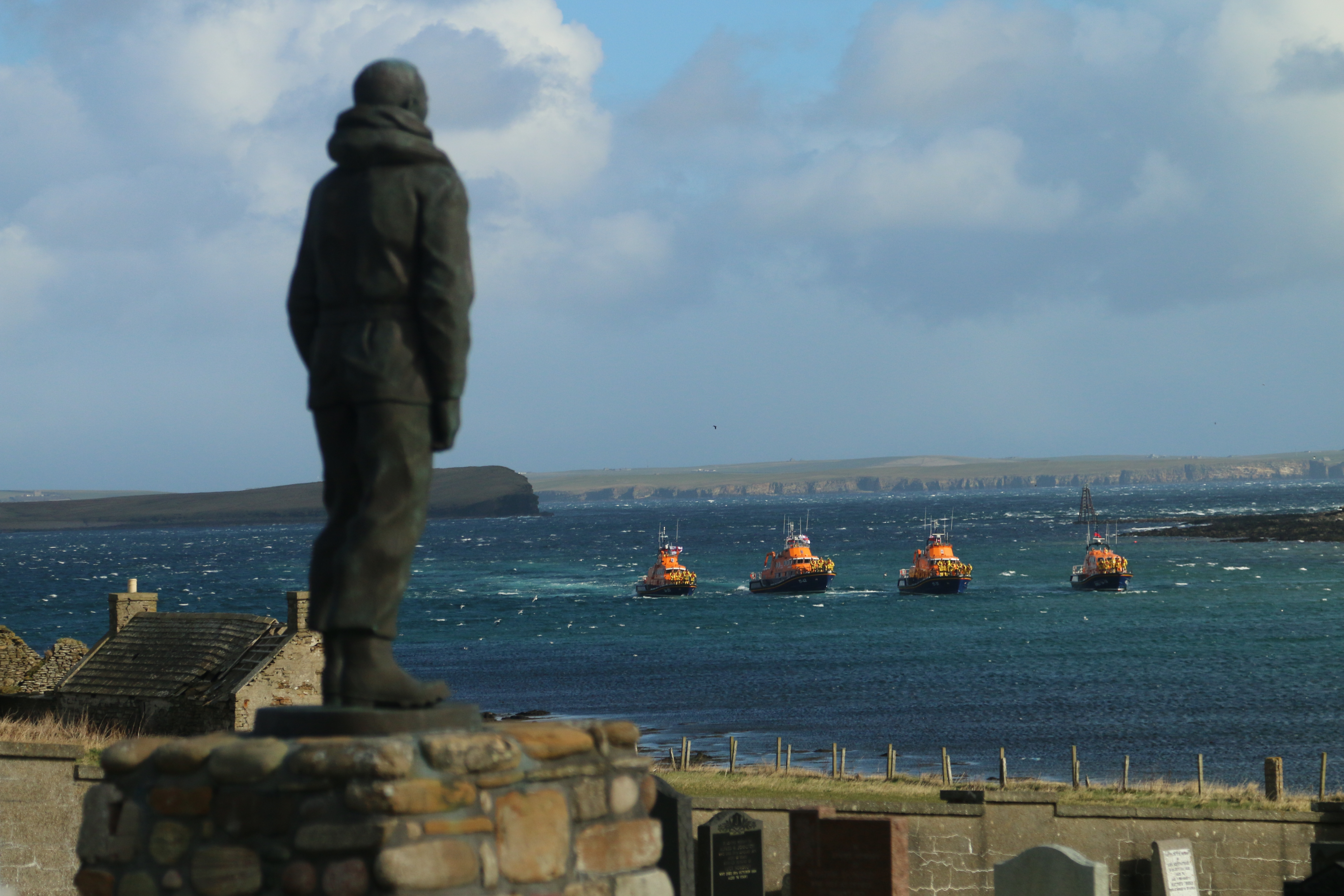 Lifeboats from Longhope, Stromness, Wick and Thurso pay their respects at the memorial to the lost crew of T.G.B