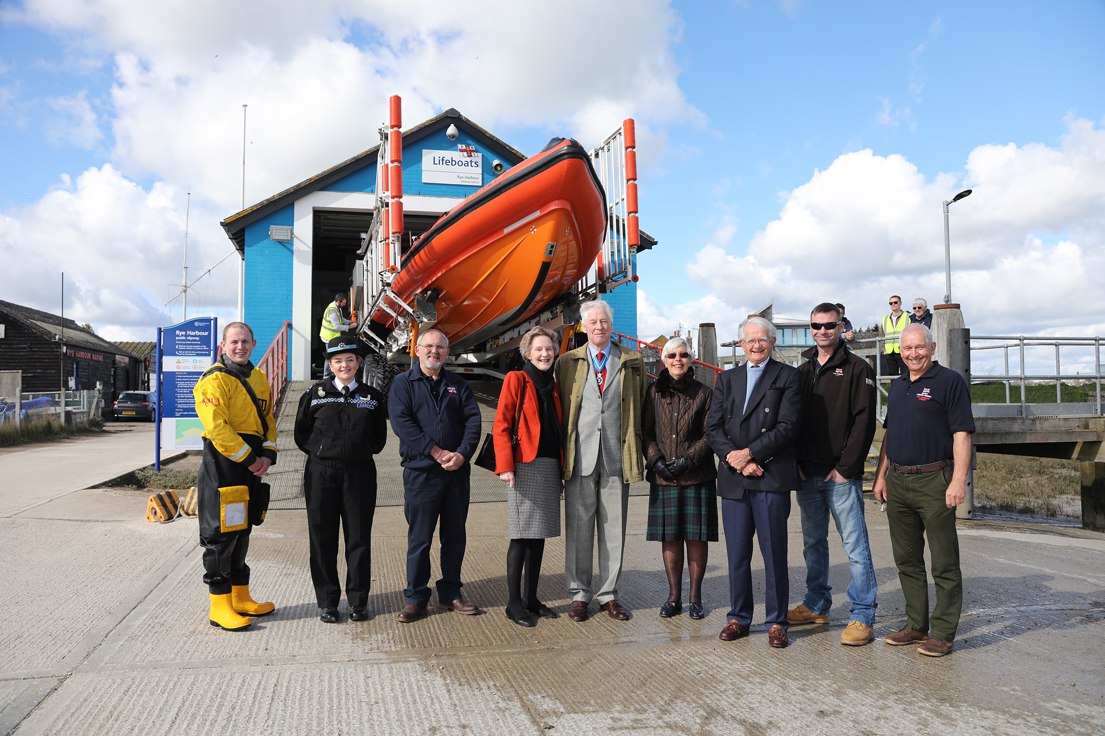 The High Sheriff of East Sussex and his party stand in front of the Atlantic 85 lifeboat with station personnel