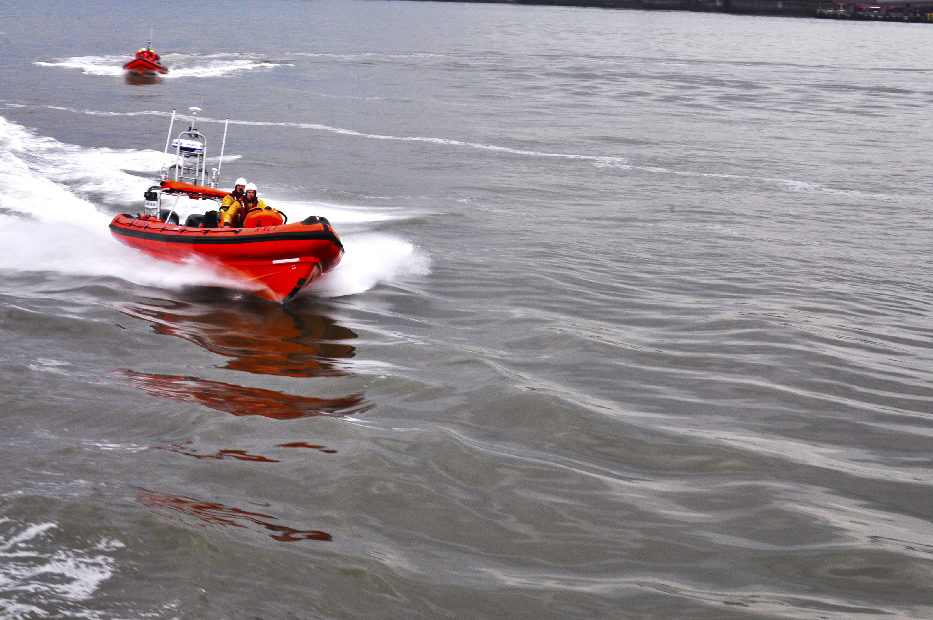 New Brighton Lifeboat in motion on the water followed some distance away by the MFRS lifeboat.