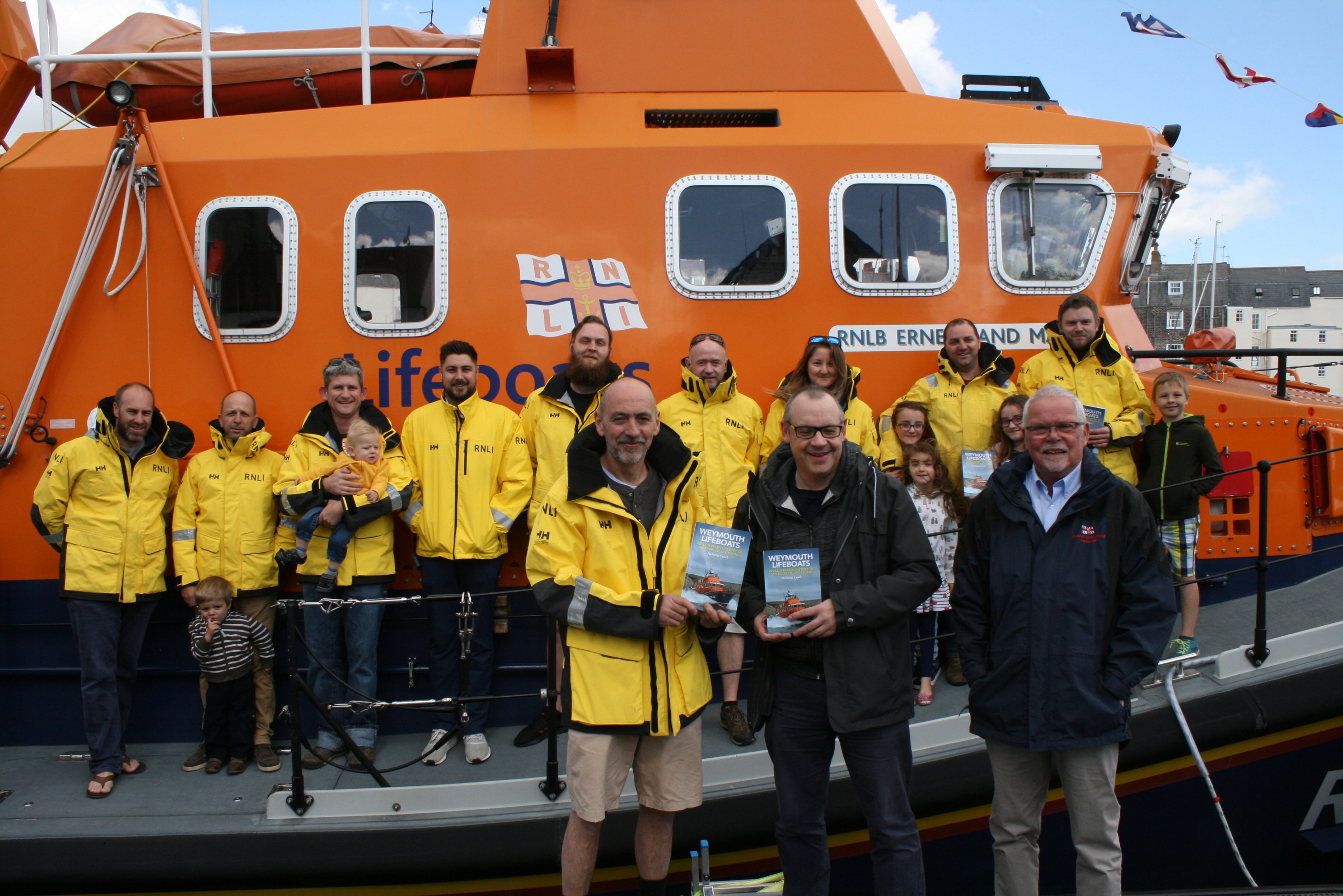 Coxswain Andy Sargent, author Nicholas Leach and LOM Malcolm Wright with some of the volunteer crew at Weymouth
