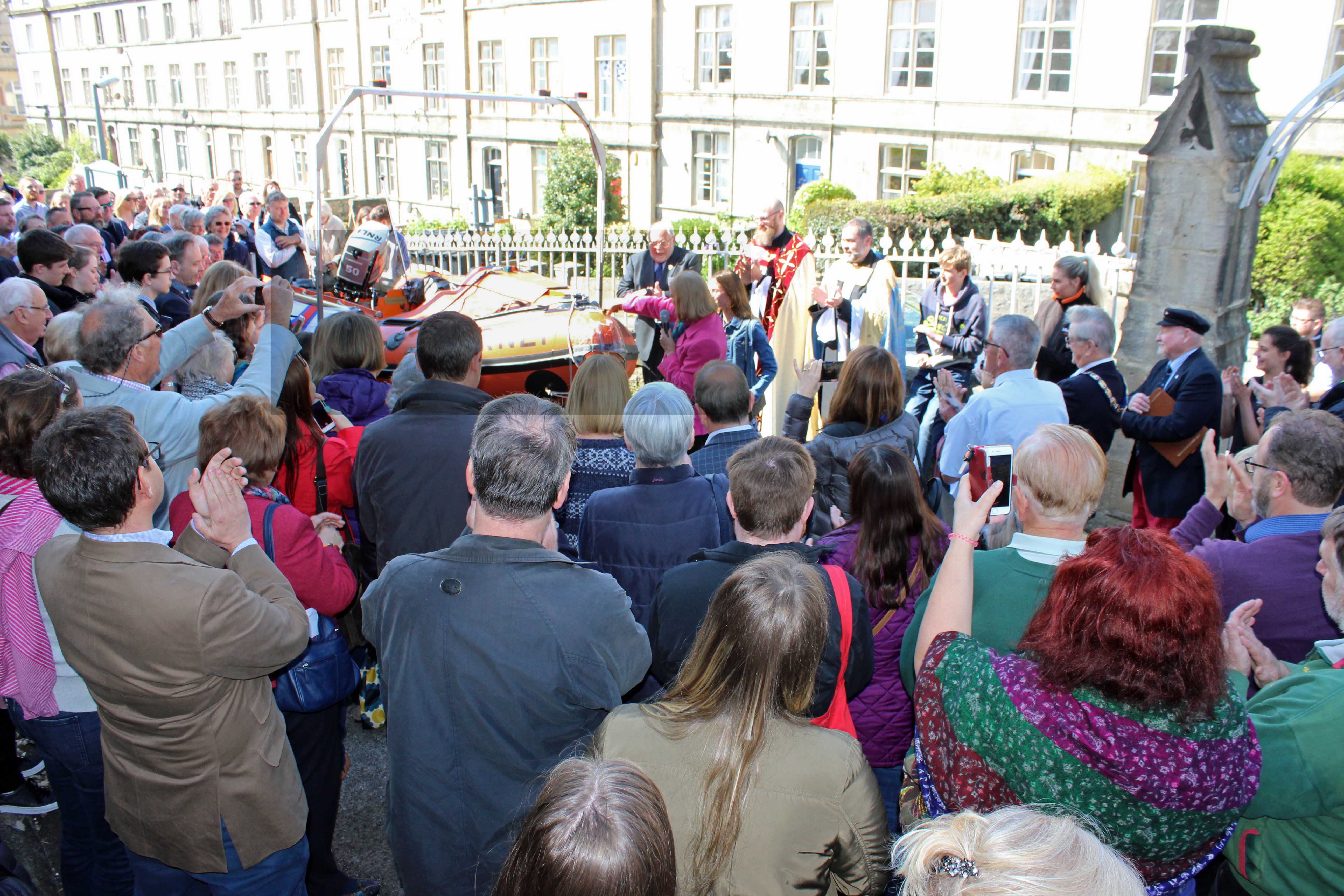 Jenny Beaumont who presented the lifeboat names it and pours champagne