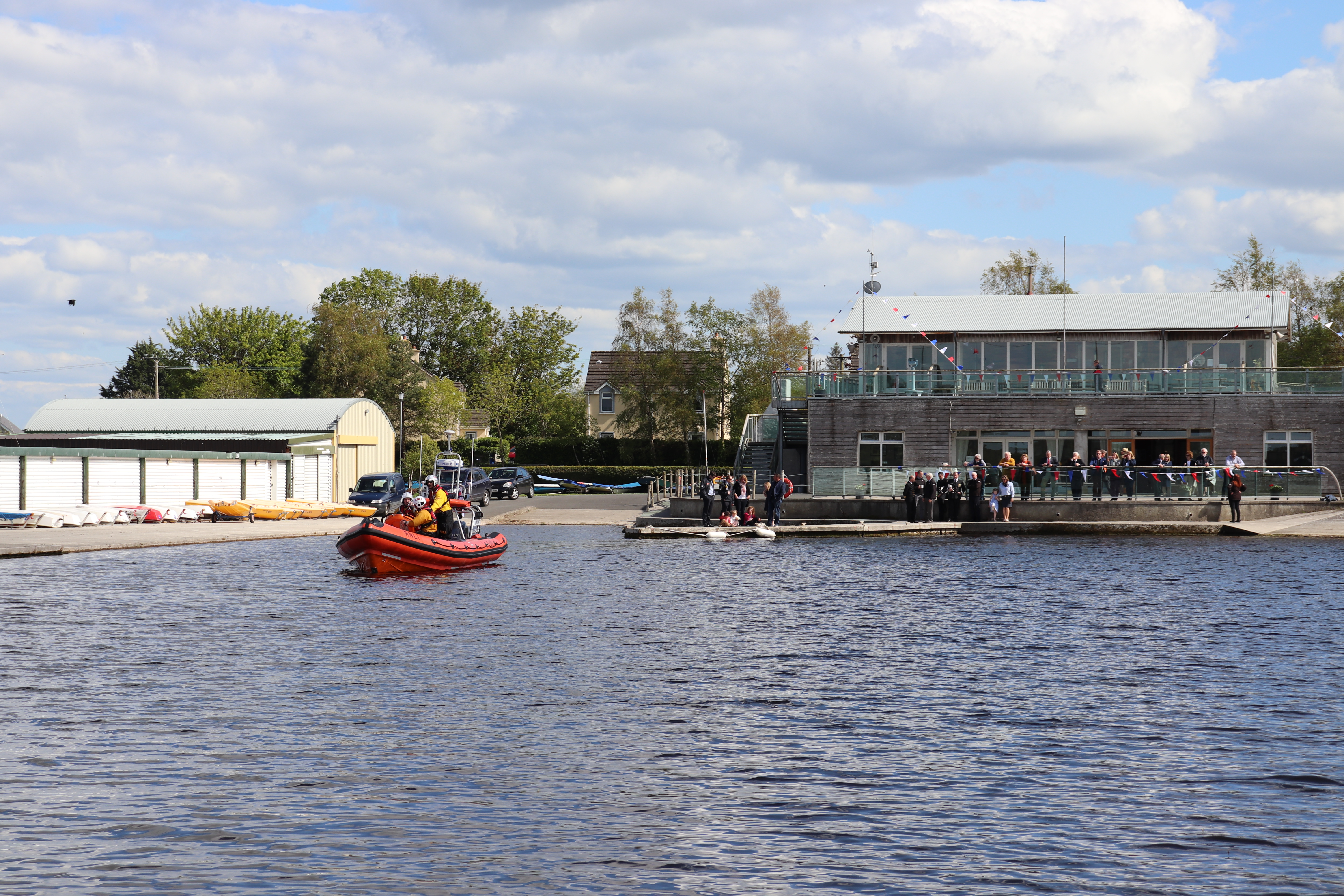 Volunteer crew take new Atlantic 85 out on lake as guests look on