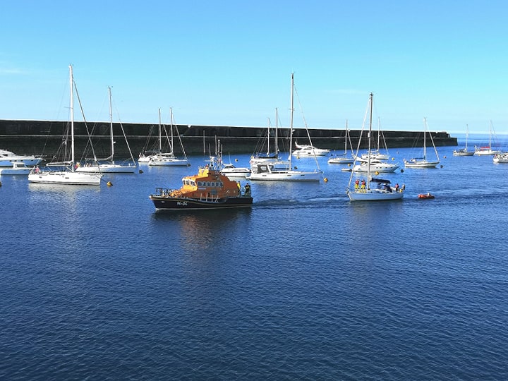 Yacht being towed to Braye Harbour