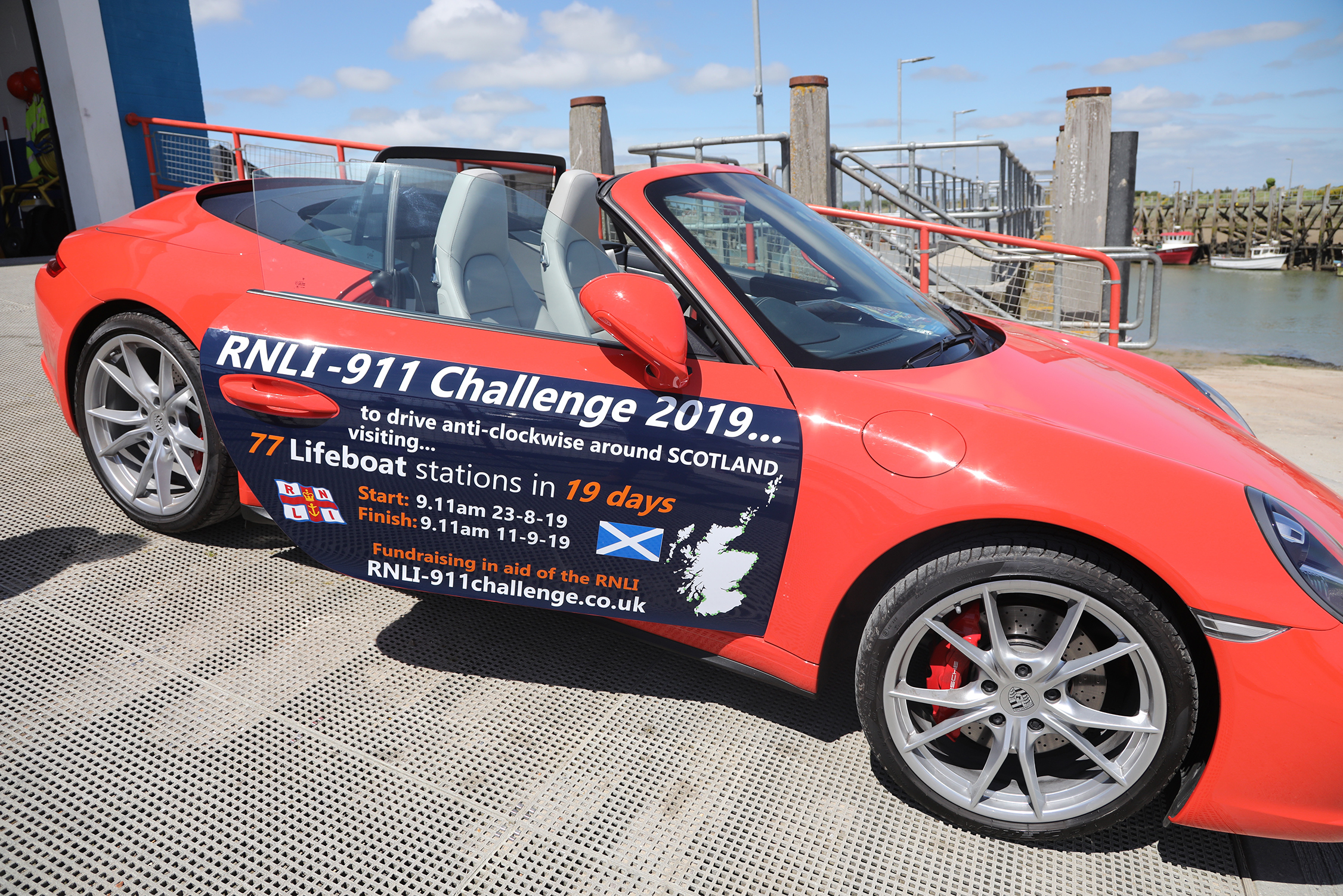 Red Porsche parked on the slipway of RNLI Rye Harbour 