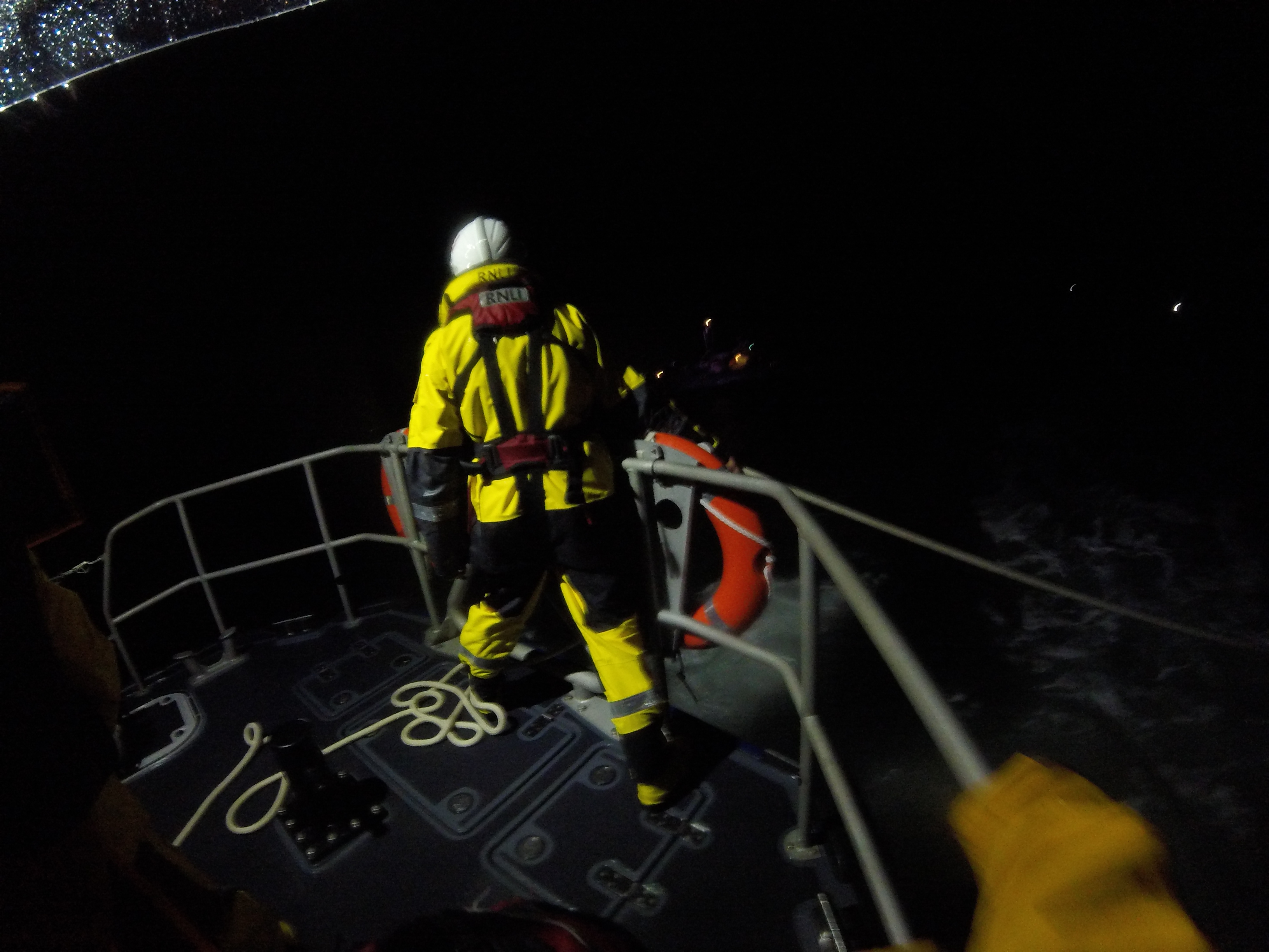 Crewman on stern of lifeboat