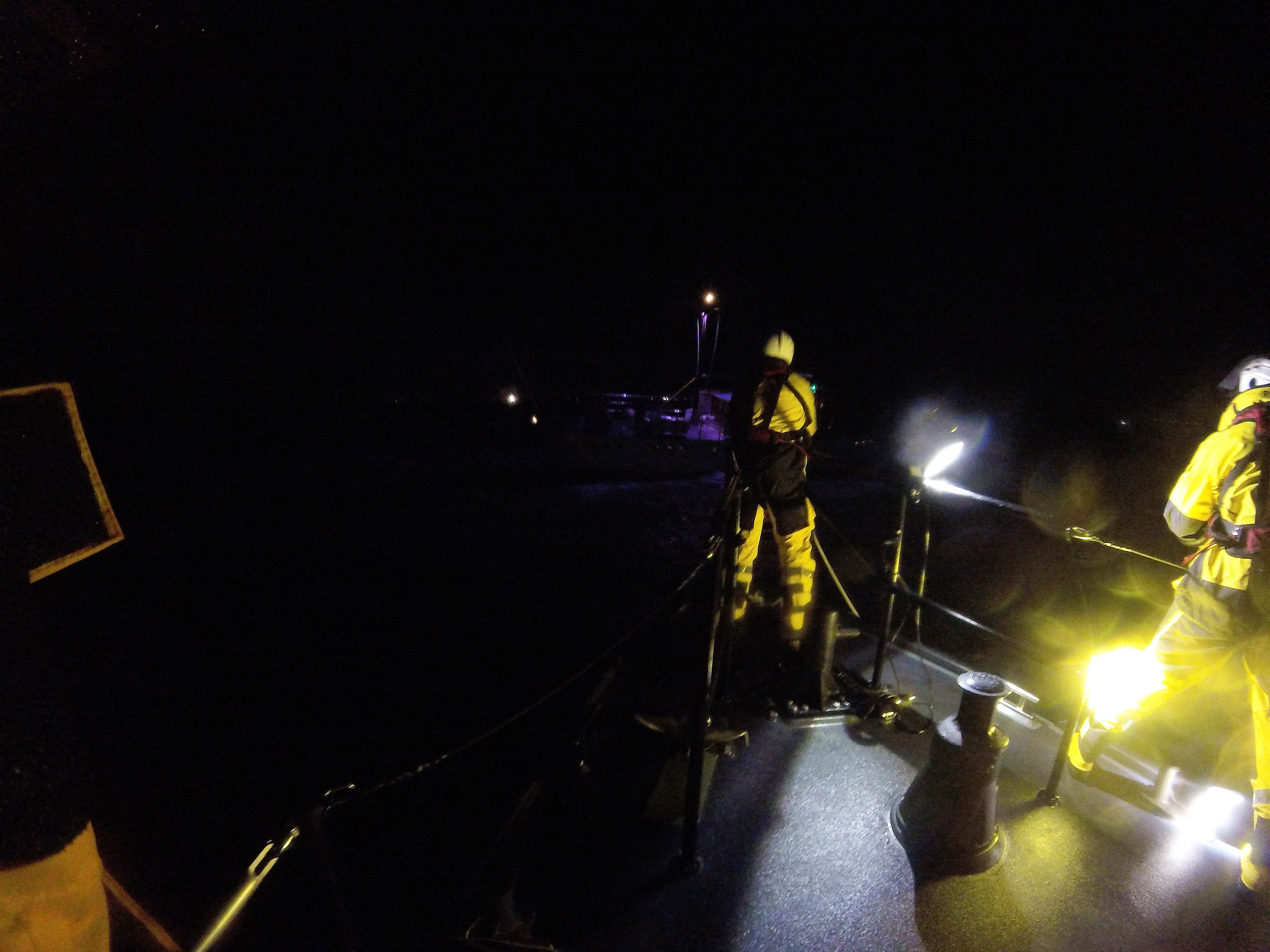 shows crew on the foredeck of lifeboat