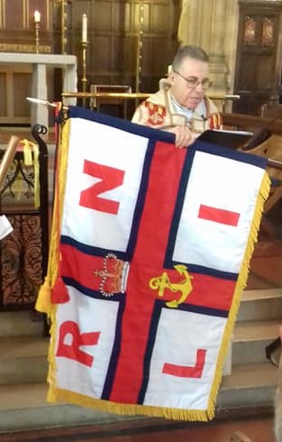 Rev. Andrew Gough blessing the standard