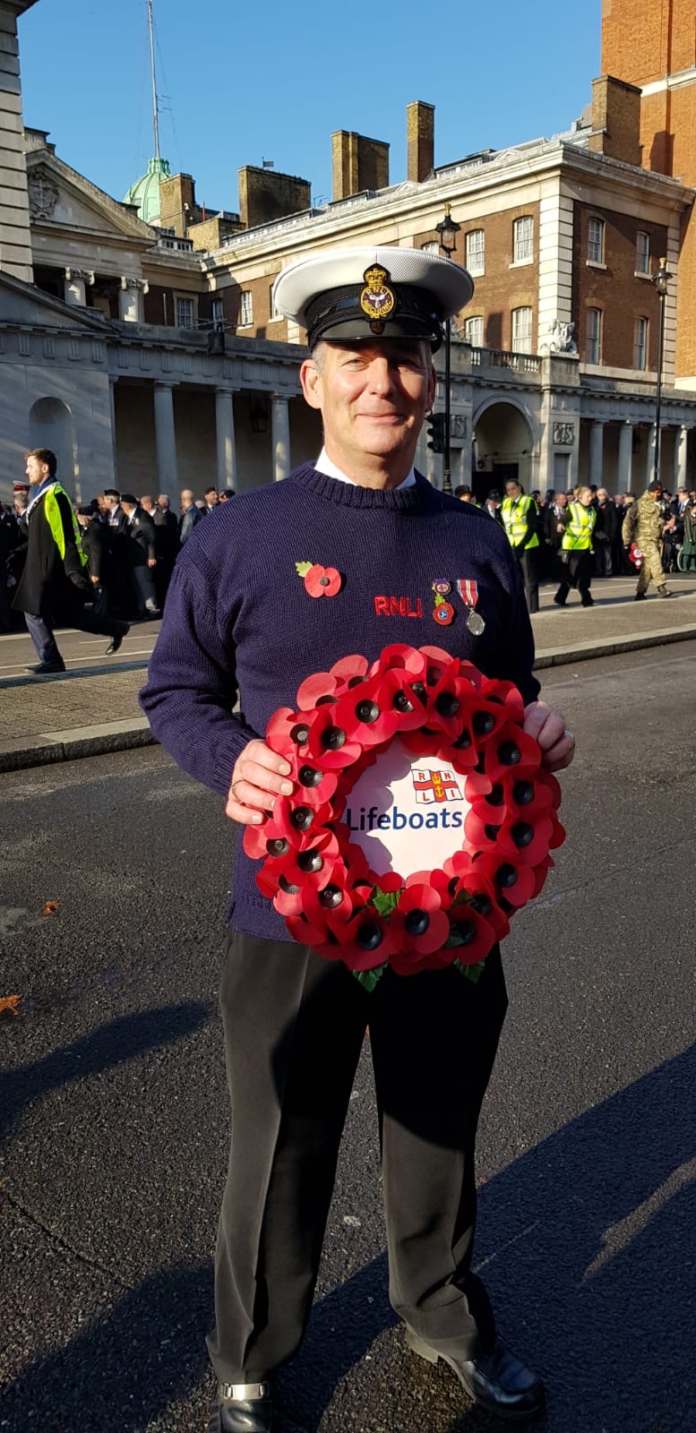 Lifeboat man holding a poppy wreath
