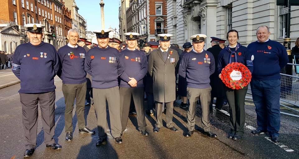 Lifeboat crew holding a poppy wreath