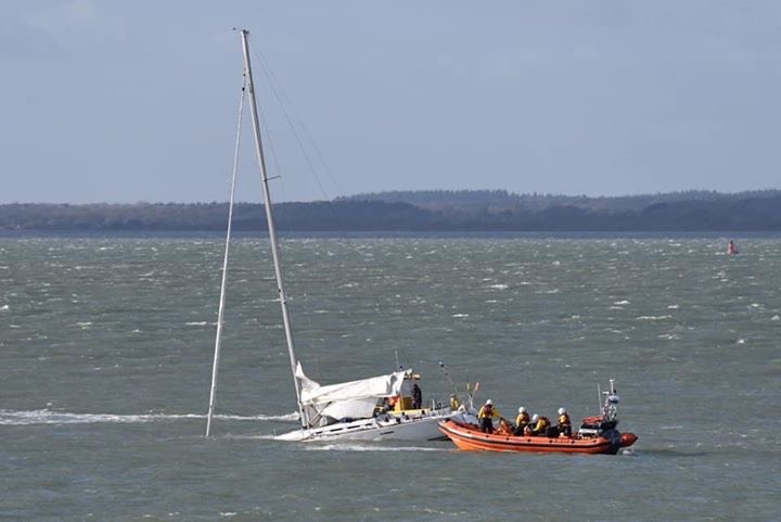 Wide shot showing the lifeboat alongside the yacht.