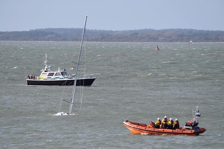 Photo of the yacht almost completely submerged and an RNLI lifeboat.