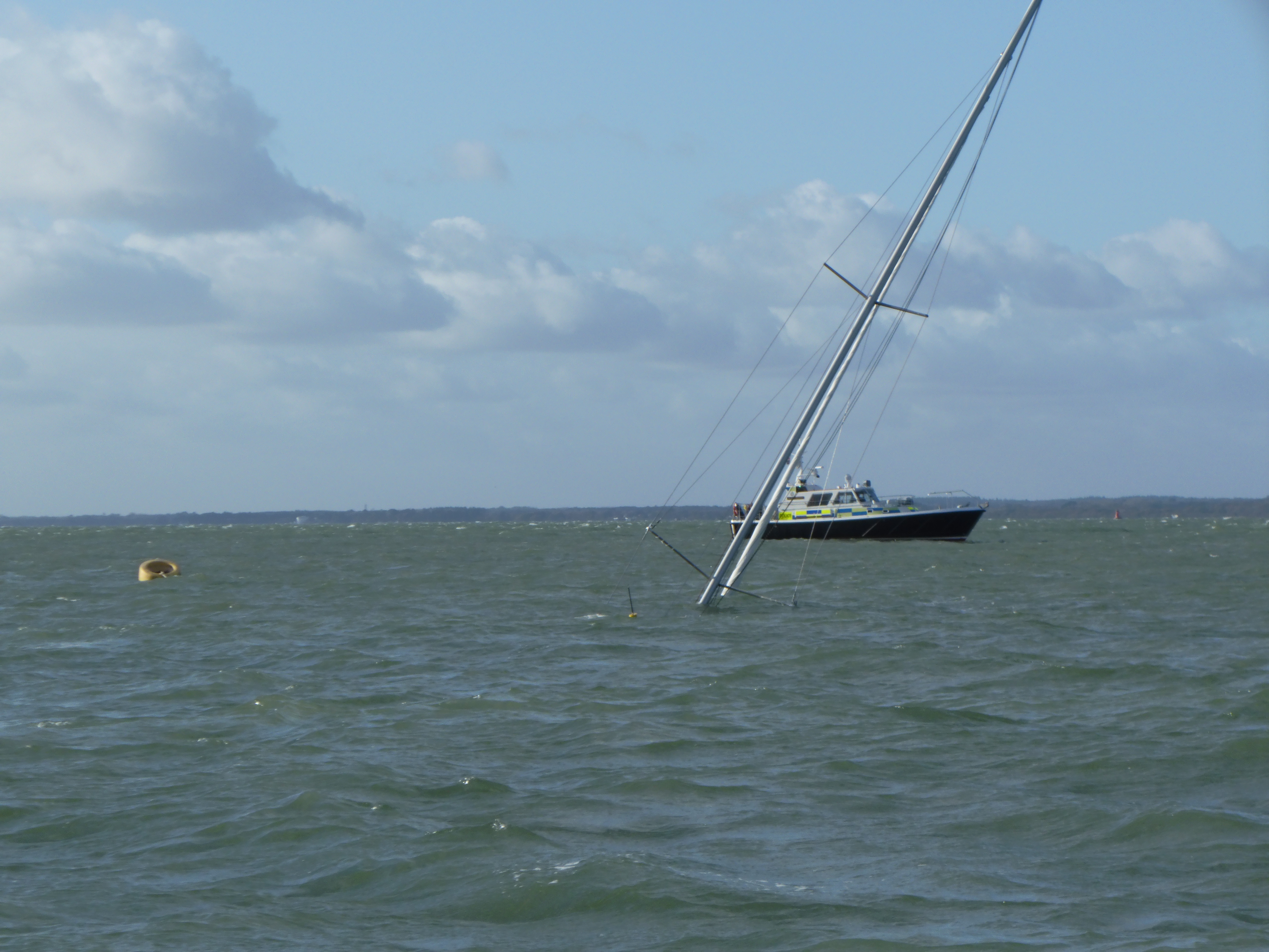 Shot showing just the mast sticking out of the water.