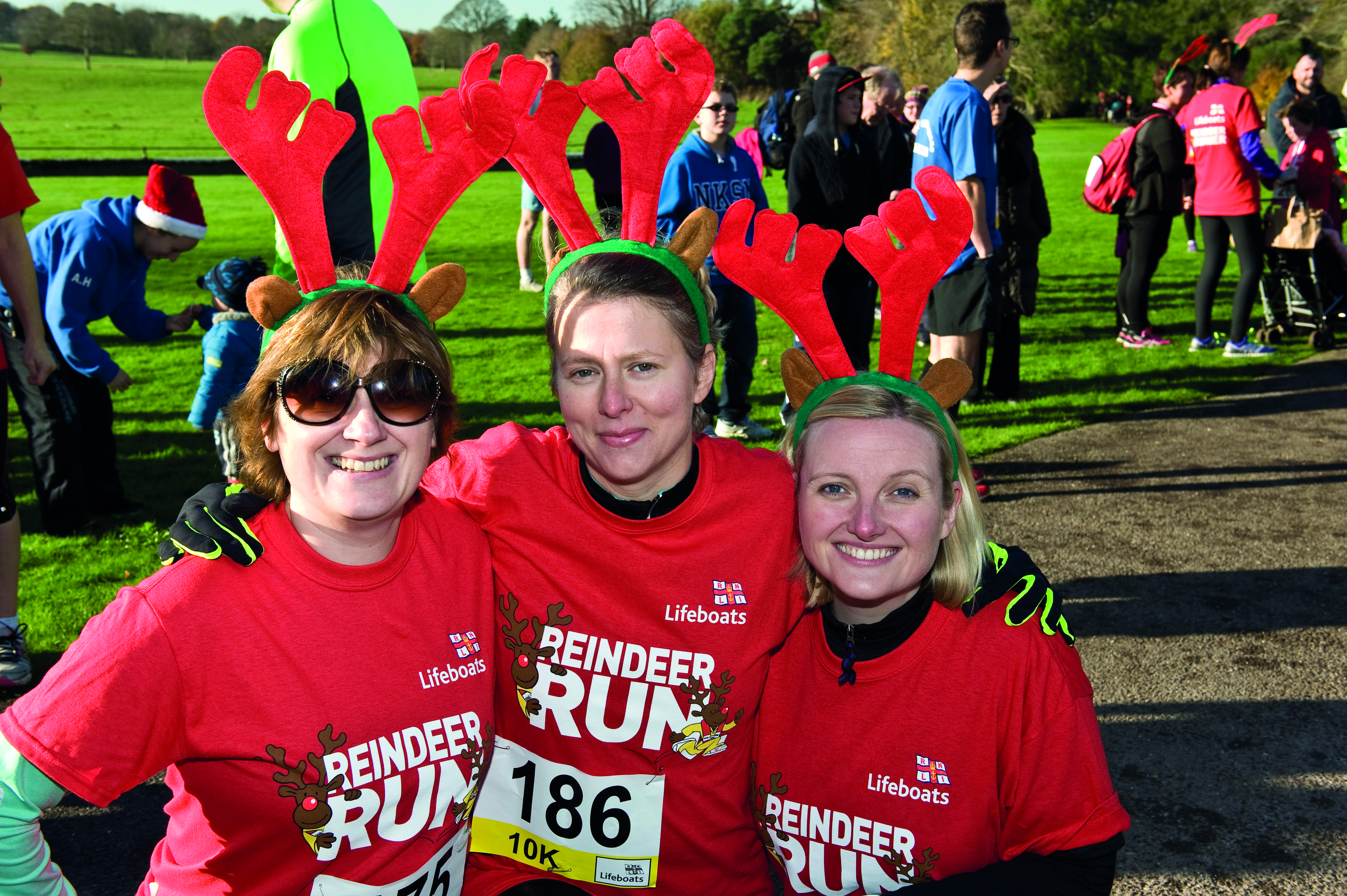 Photo of three past participants in the RNLI's Reindeer Run.